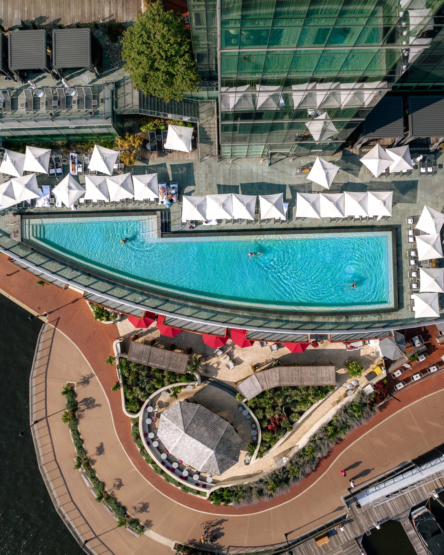 Aerial view of a rooftop pool with cabanas.