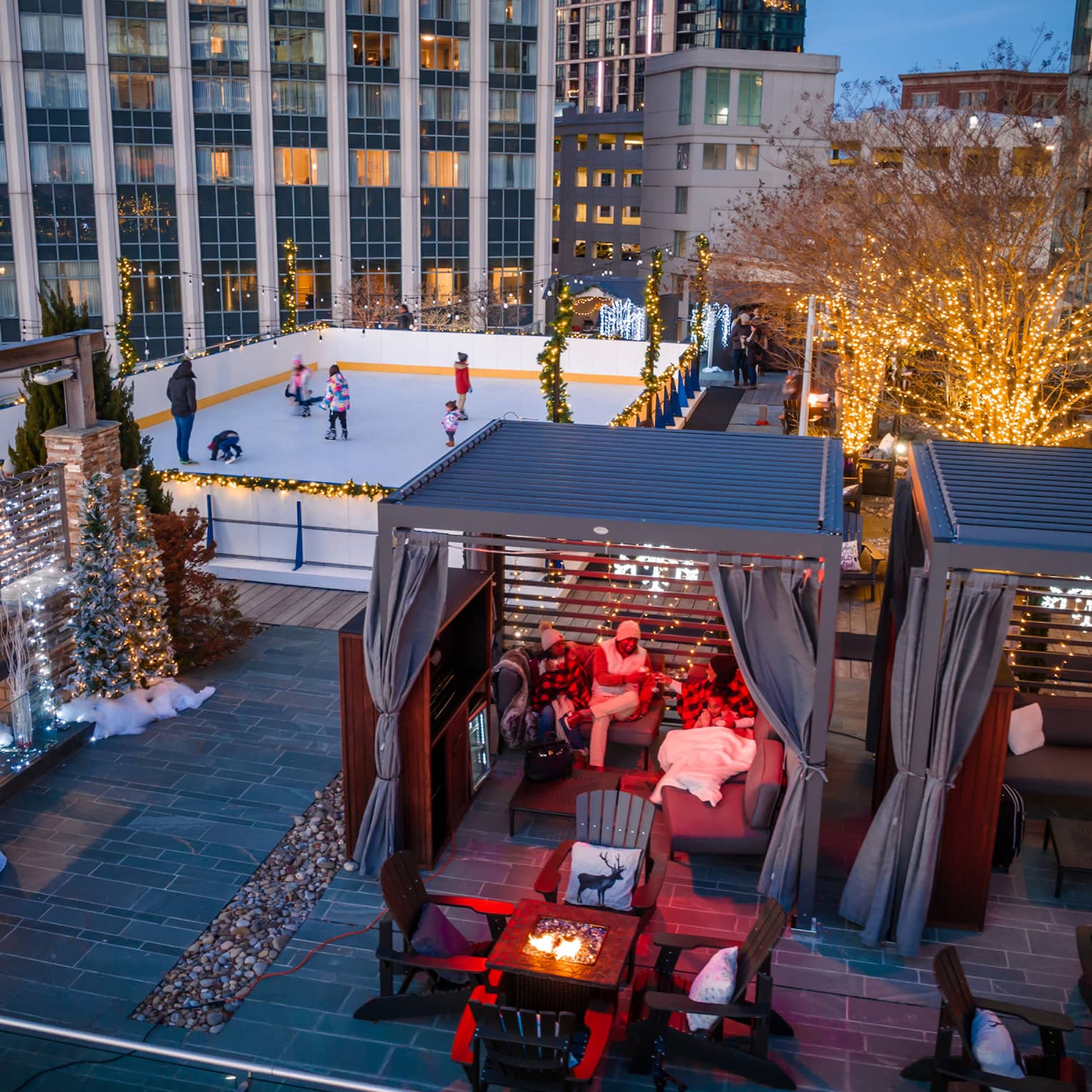 A rooftop with ice skating, and chalets.