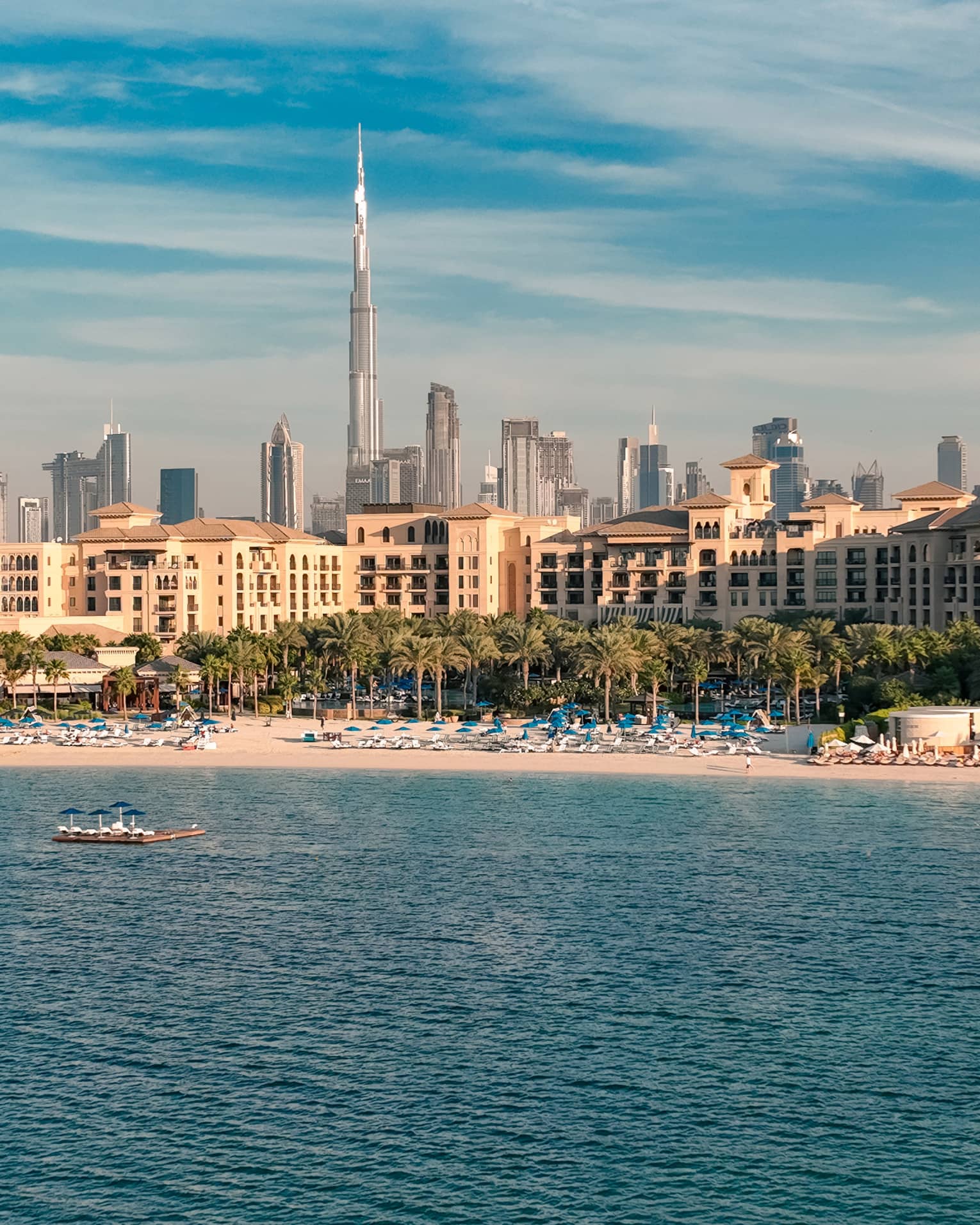 An aerial view of Jumeirah Beach from the sea with a view of downtown in the distance.