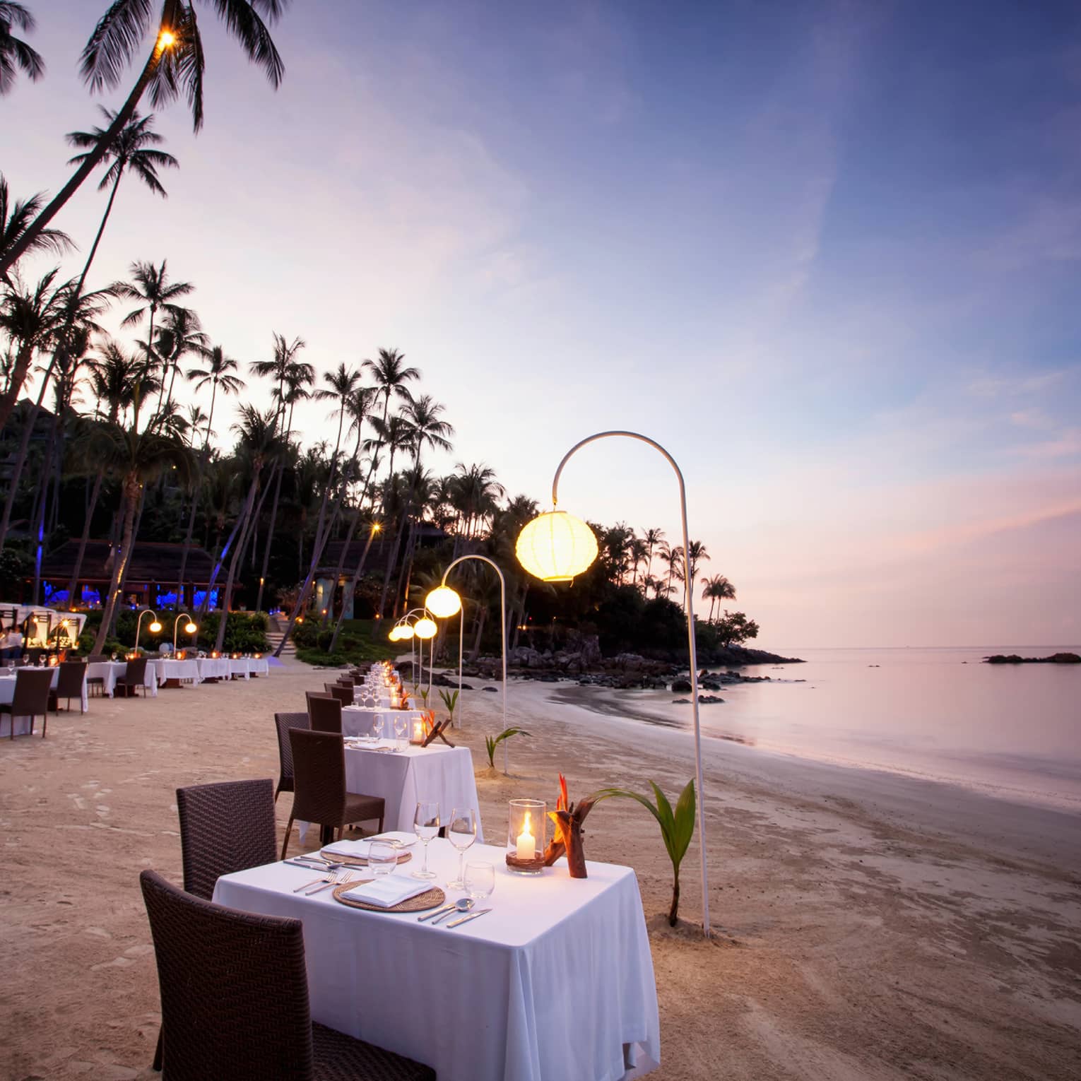 Barbecue on the beach with dining tables on the sand