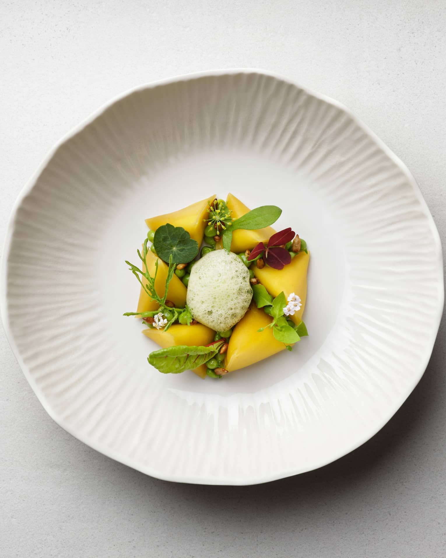 ,Colourful food on a cream coloured plate.