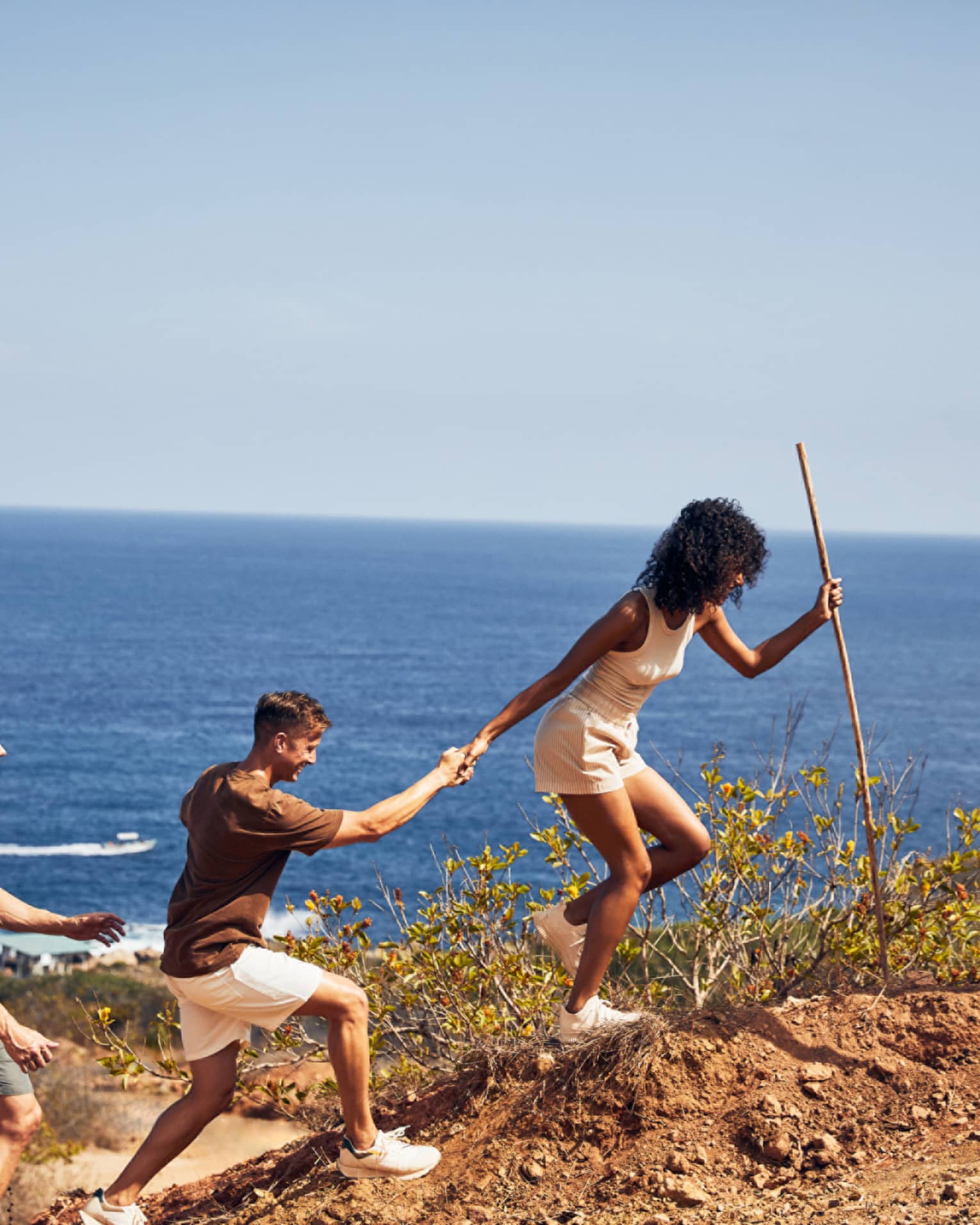 A group of people hiking along a beach.