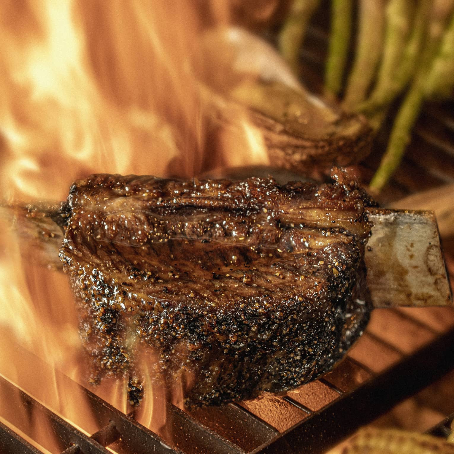 Close-up of chargrilled steak, asparagus and corn on grill grates