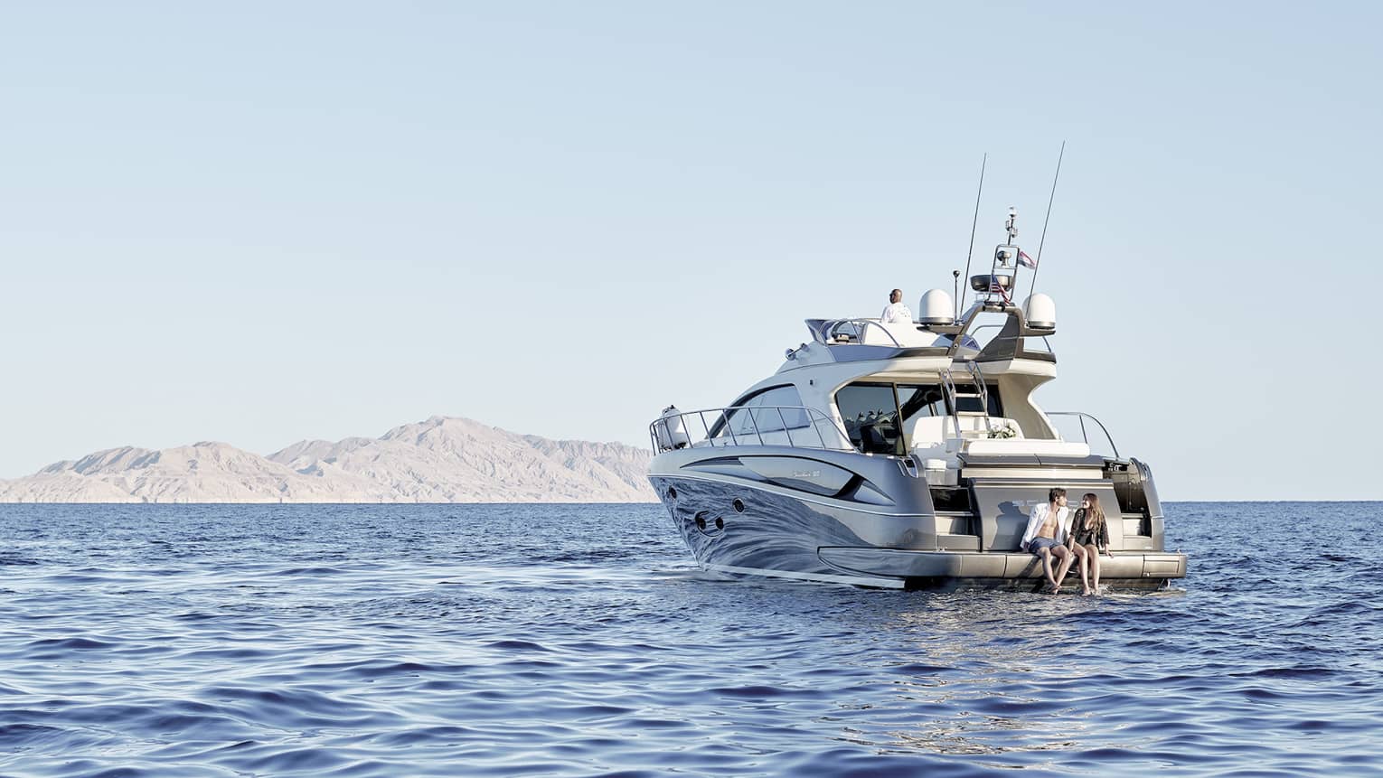 A couple on a luxury boat trip in the middle of the sea