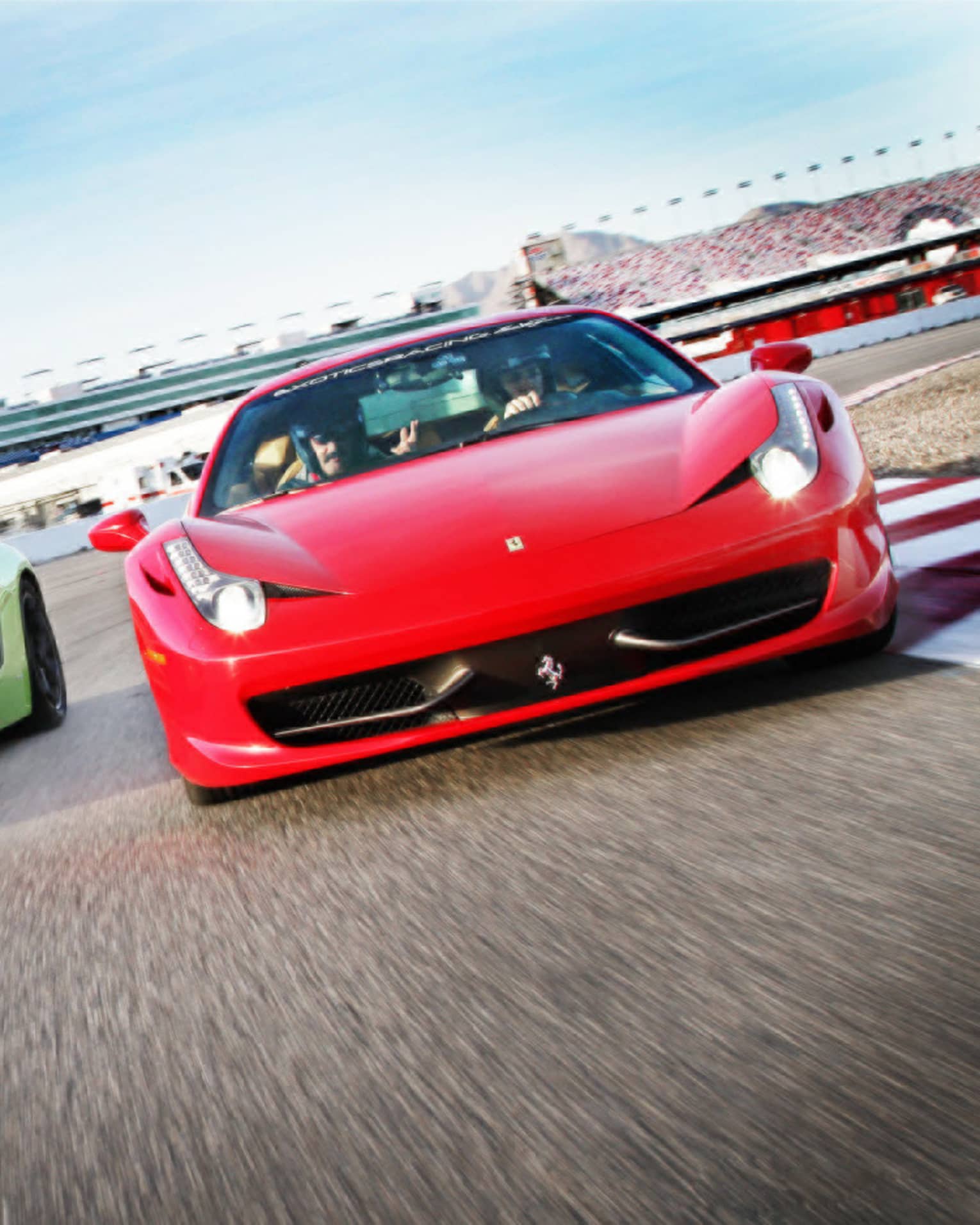 Red and green sports cars on race track