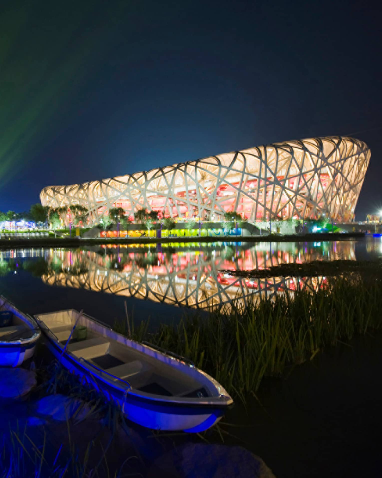 Exterior of Beijing National Stadium bird's nest-shaped building lit up at night