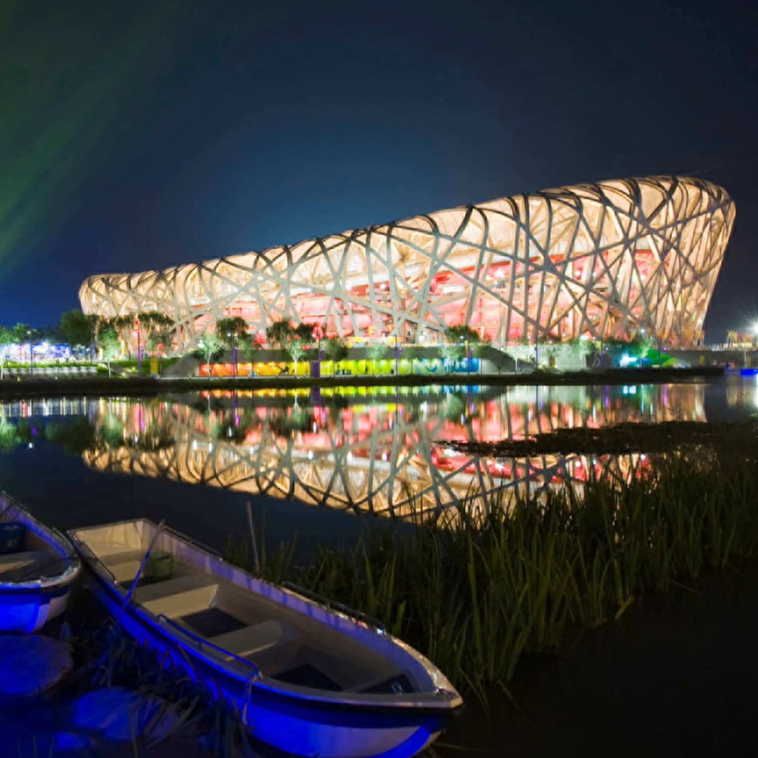 Exterior of Beijing National Stadium bird's nest-shaped building lit up at night