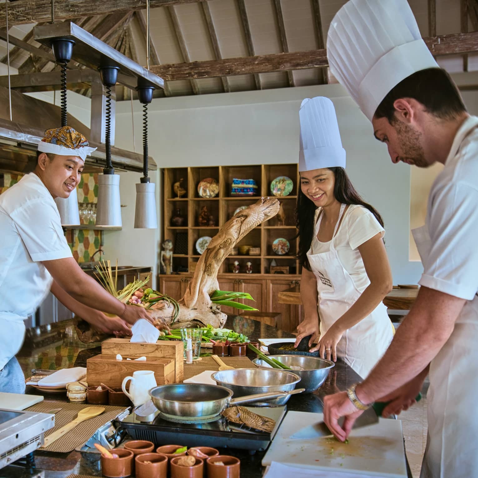 Two guests receive cooking lesson at Four Seasons hotel