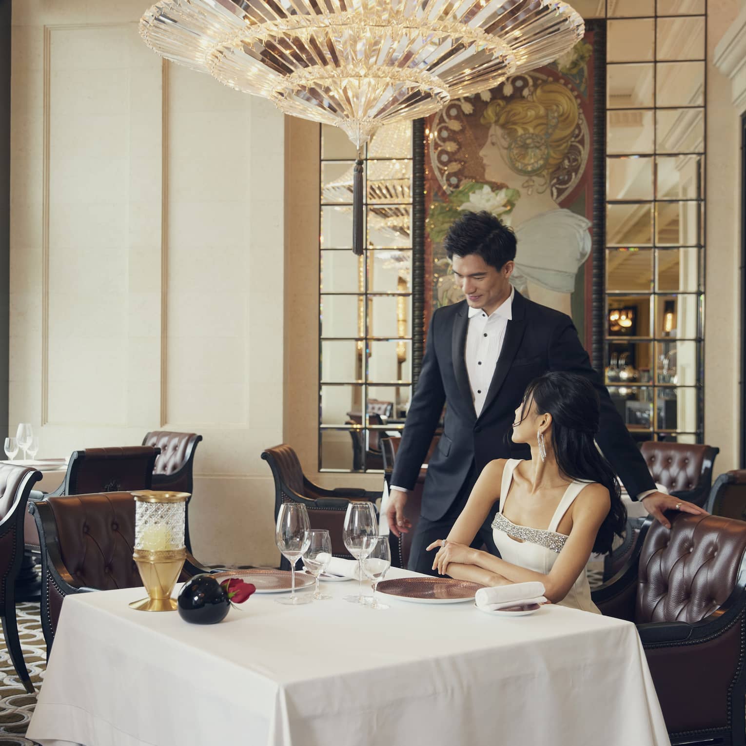 Man and woman dine at white-cloth table at Michelin-starred Caprice restaurant at Four Seasons Hotel Hong Kong