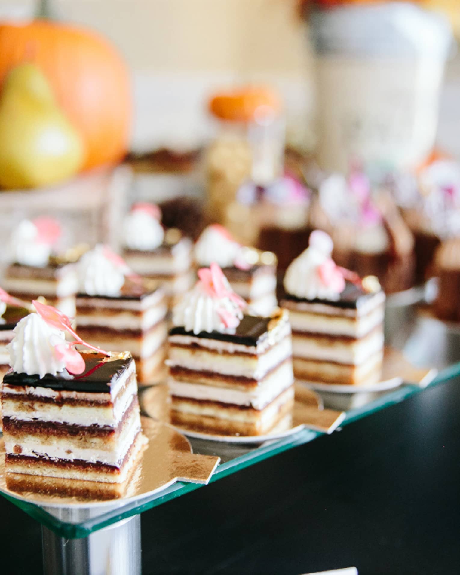 Small deserts on a glass shelf.