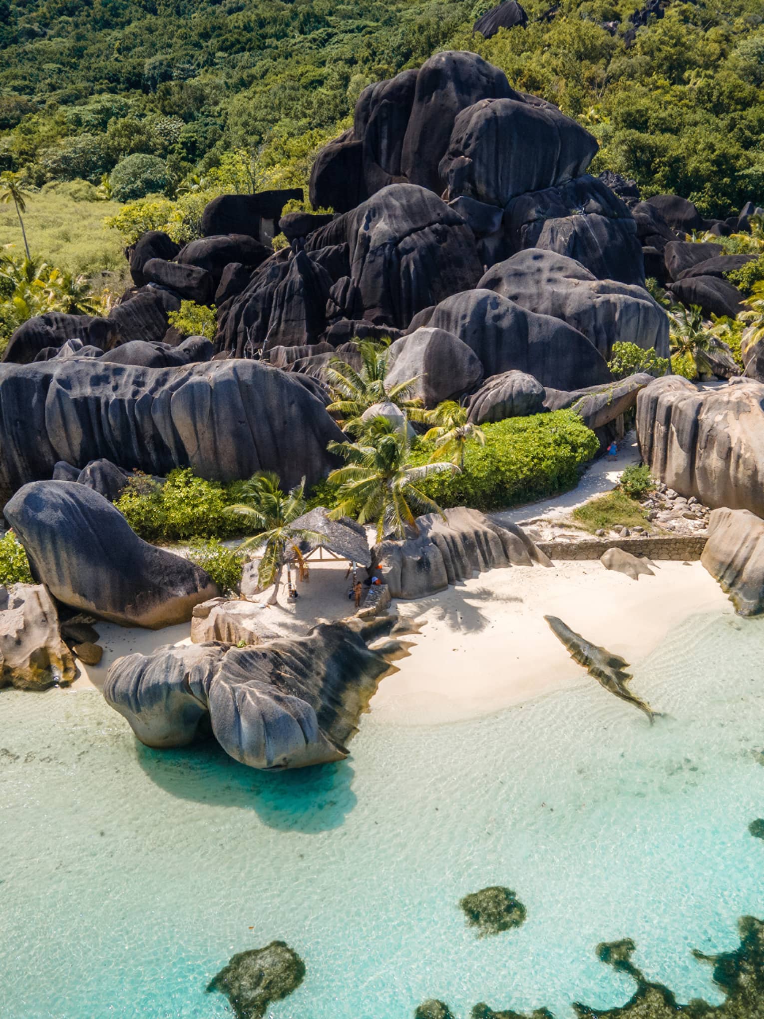 Rocky island white-sand beach with clear turquoise water