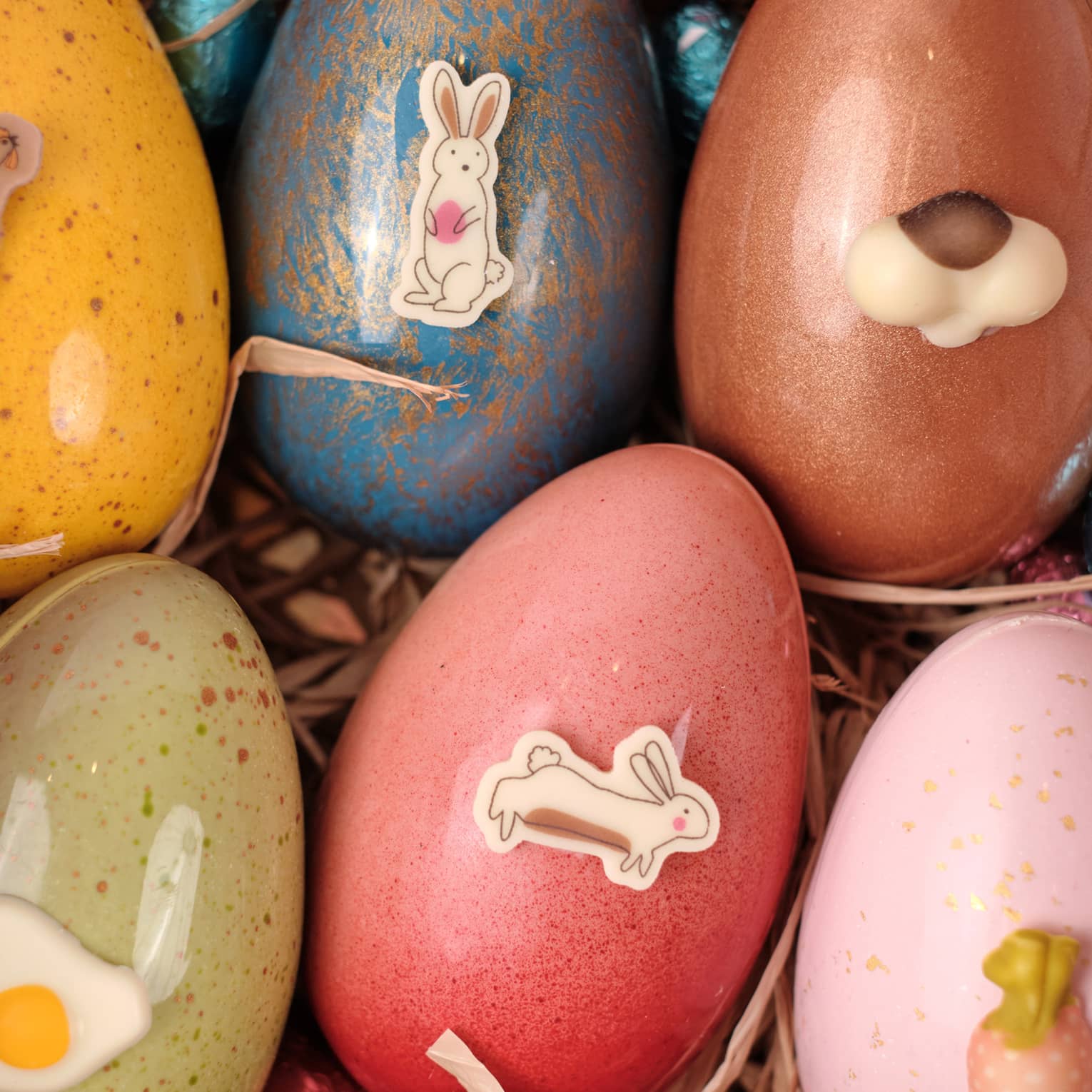 Colourful Easter eggs with Easter stickers on them.
