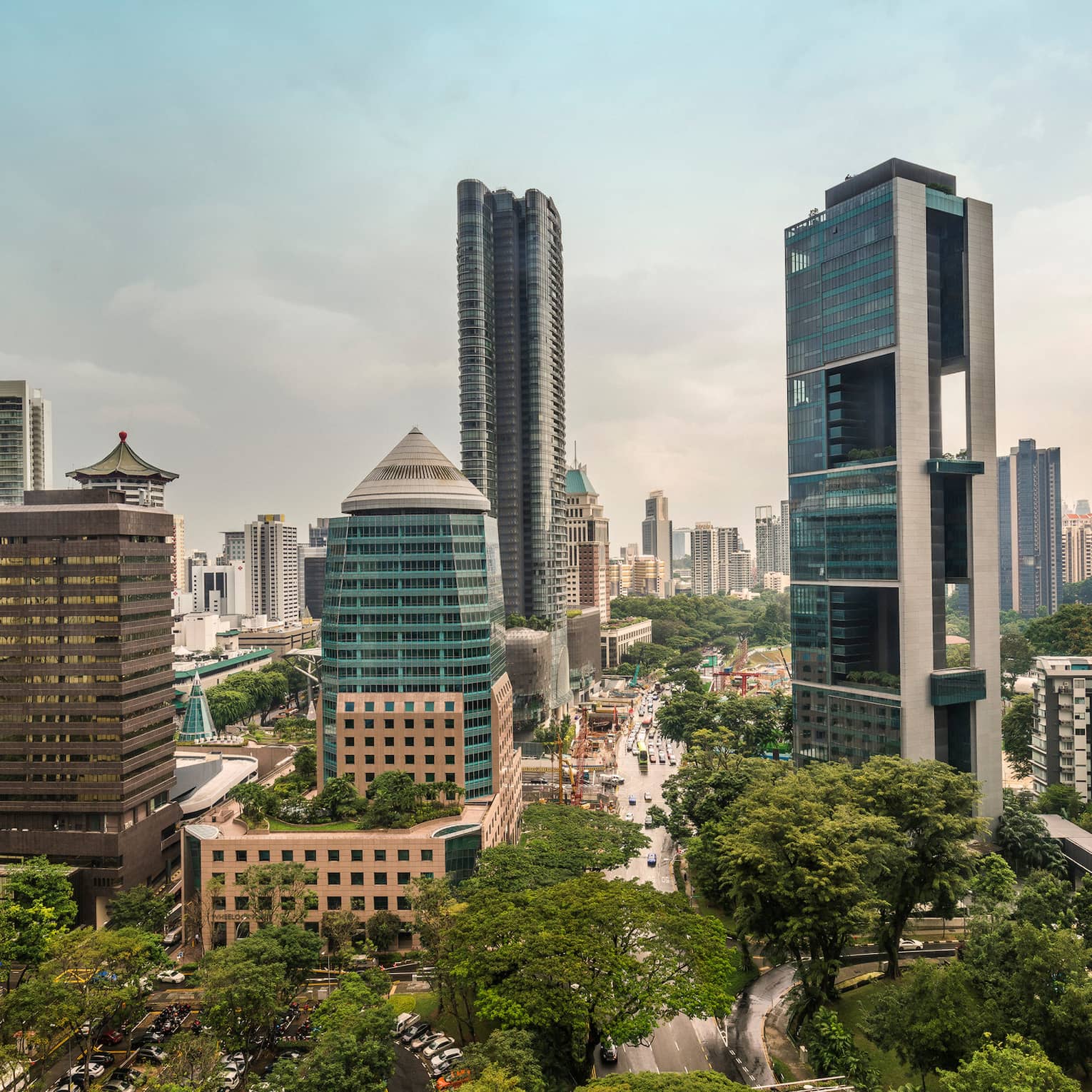 Scenic city view showcasing modern skyscrapers and lush greenery.