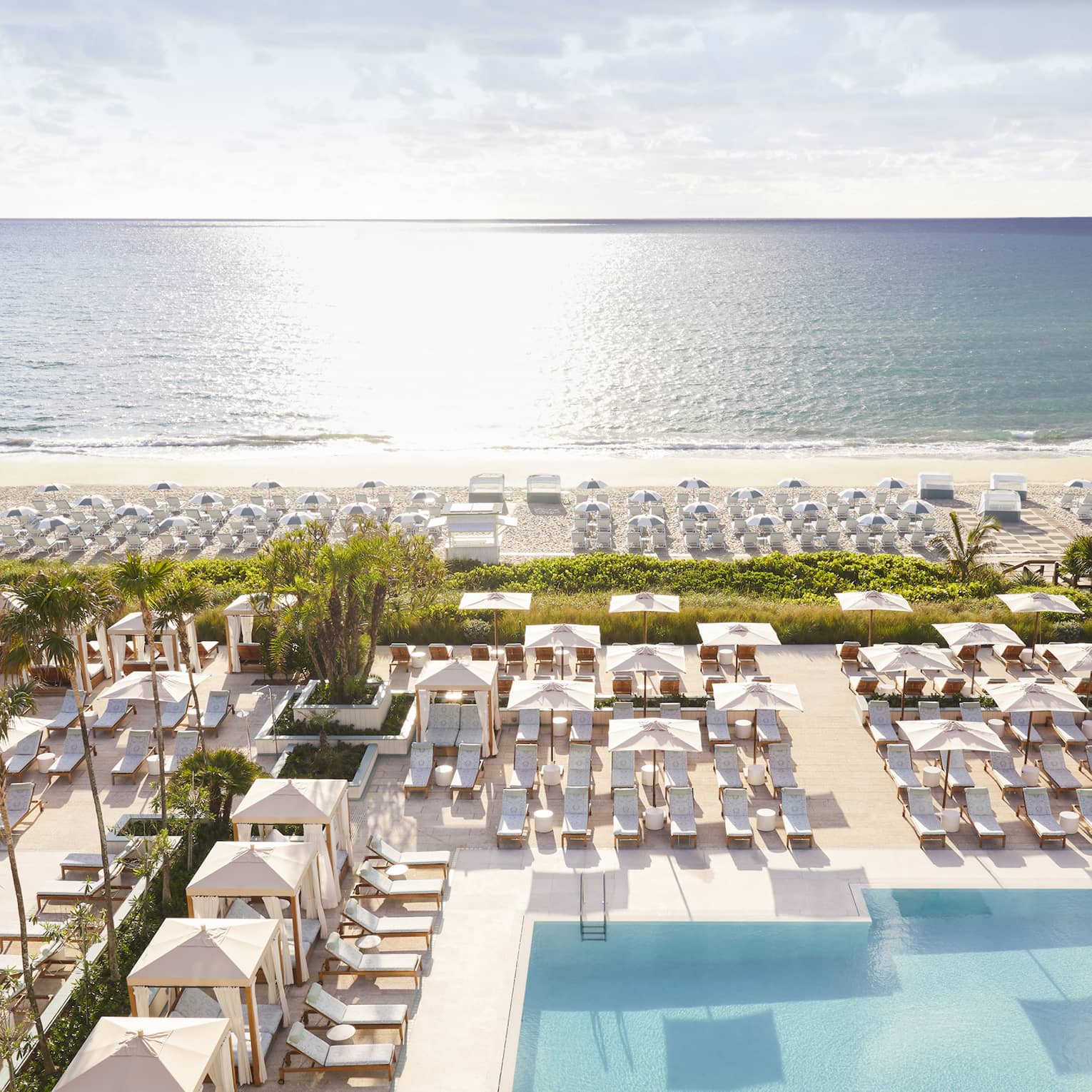 Aerial view of sprawling Four Seasons Resort Palm Beach pool, patio and beach by ocean