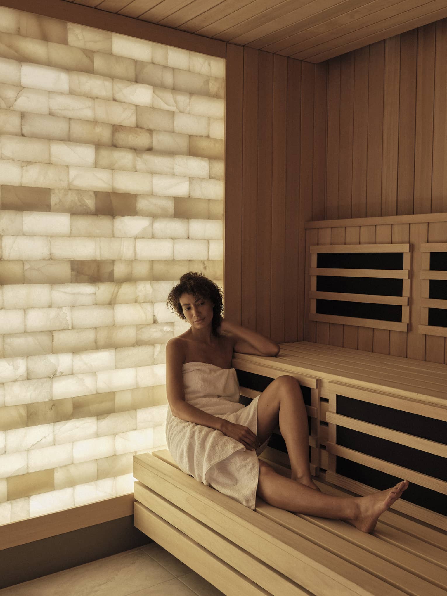 Woman relaxes in the salt-wall sauna