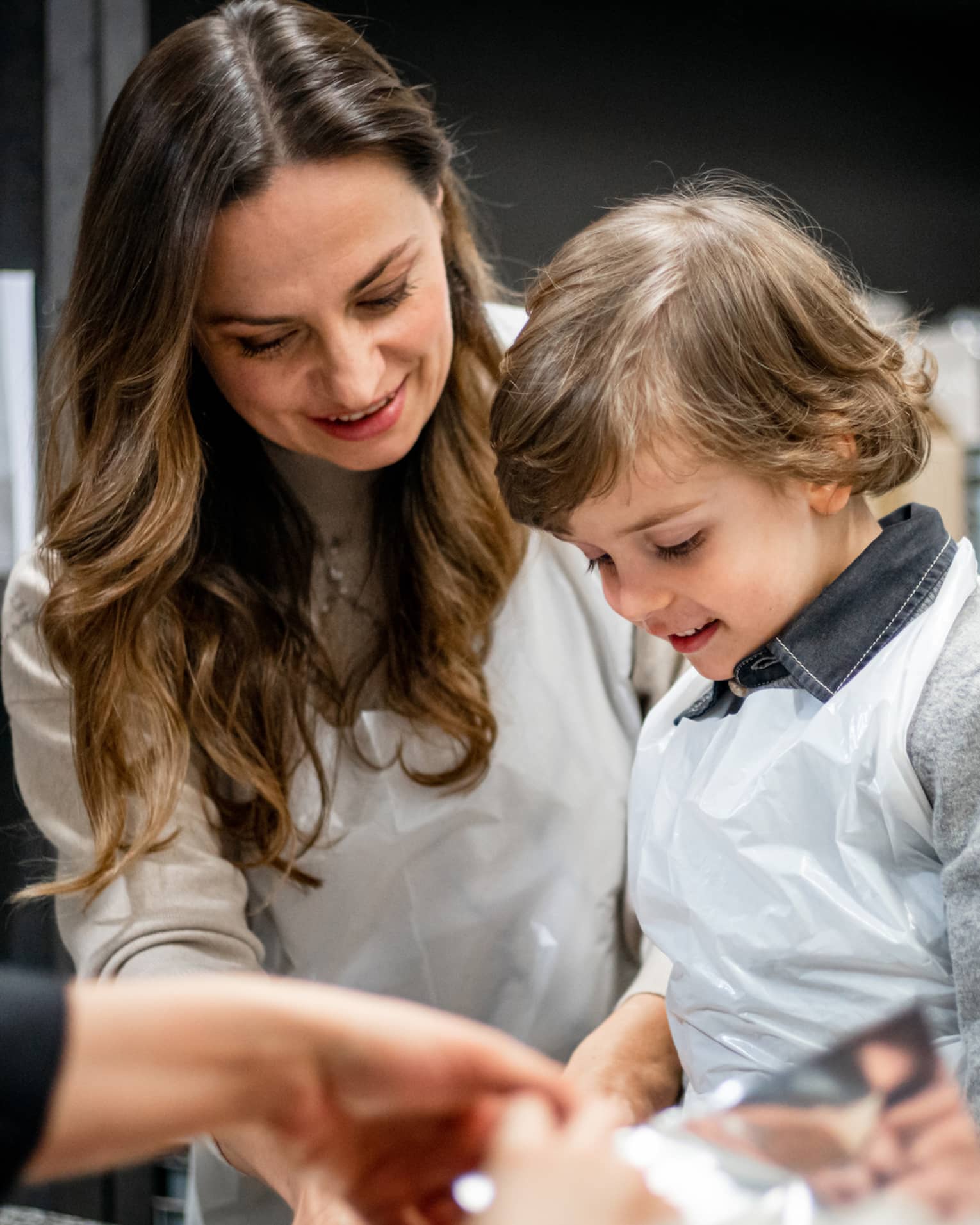 A family doing an activity in a kitchen.