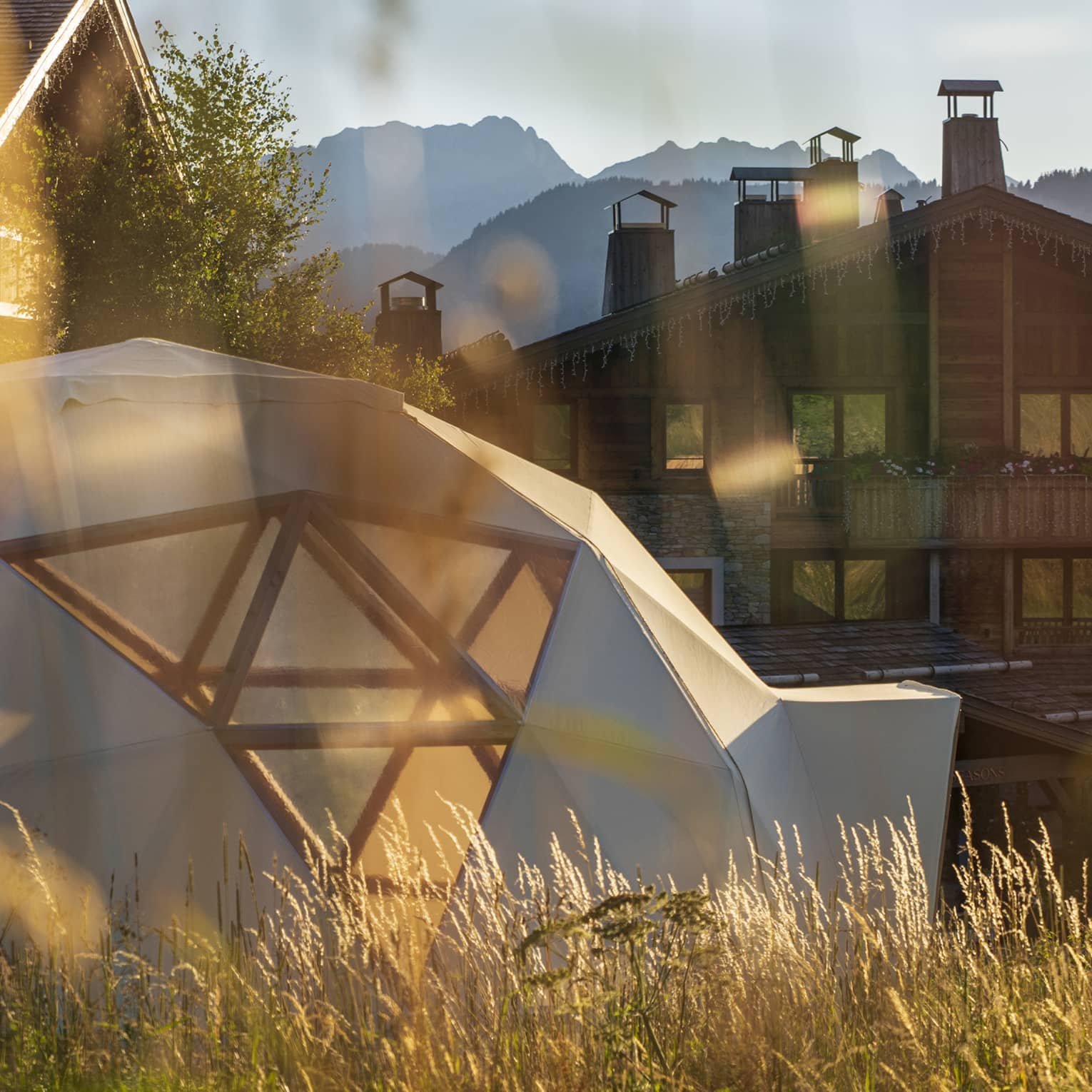 Dome on grass in front of Megeve hotel in summer