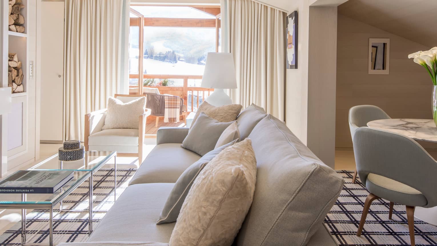 Suite Rochebrune white sofa, armchairs, glass table by modern fireplace, dining table
