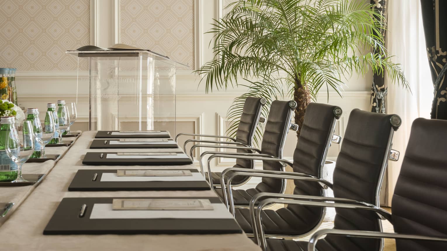 Phipps Room elegant boardroom meeting table lined with black executive chairs