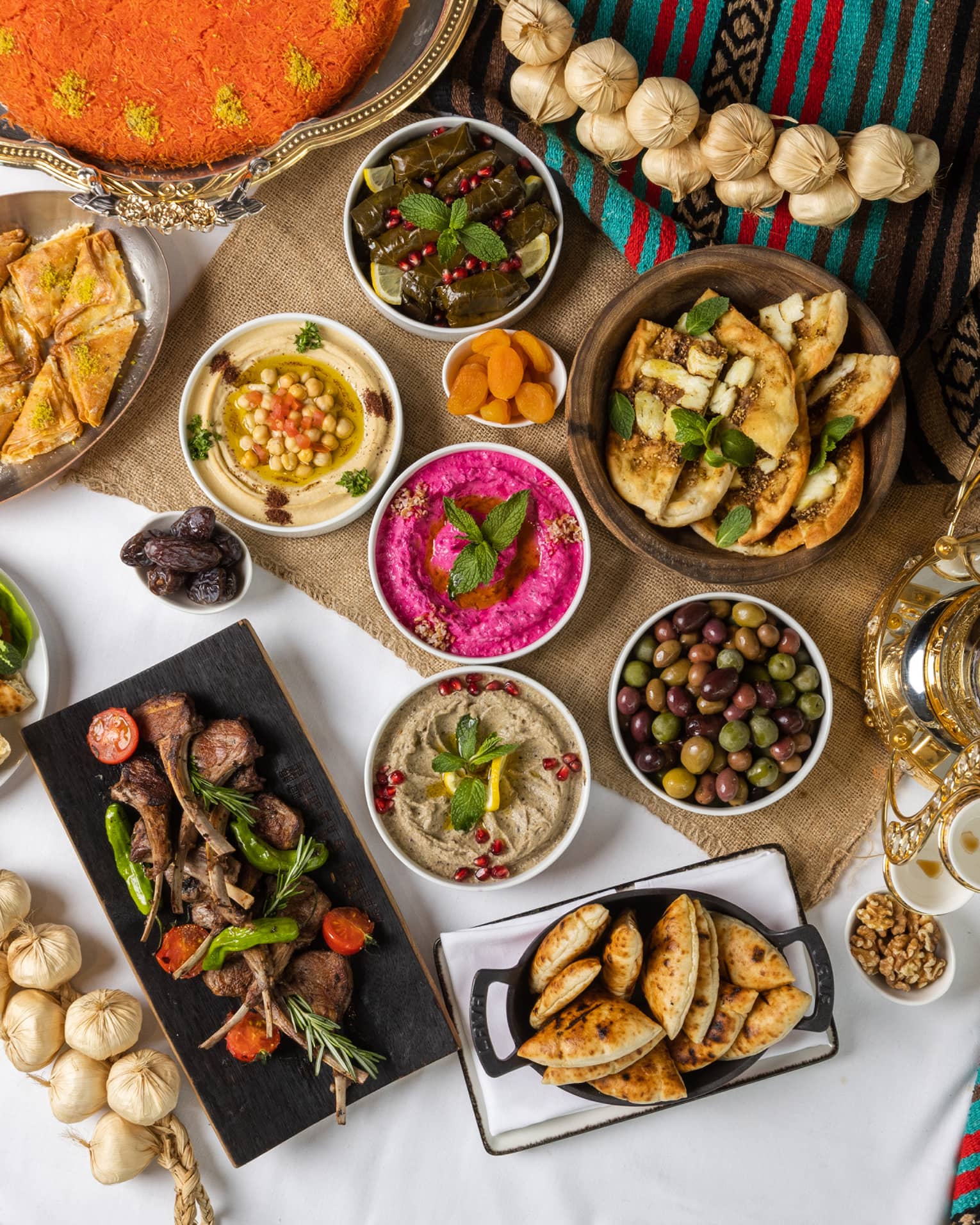A large assortment of food on a colourful table.