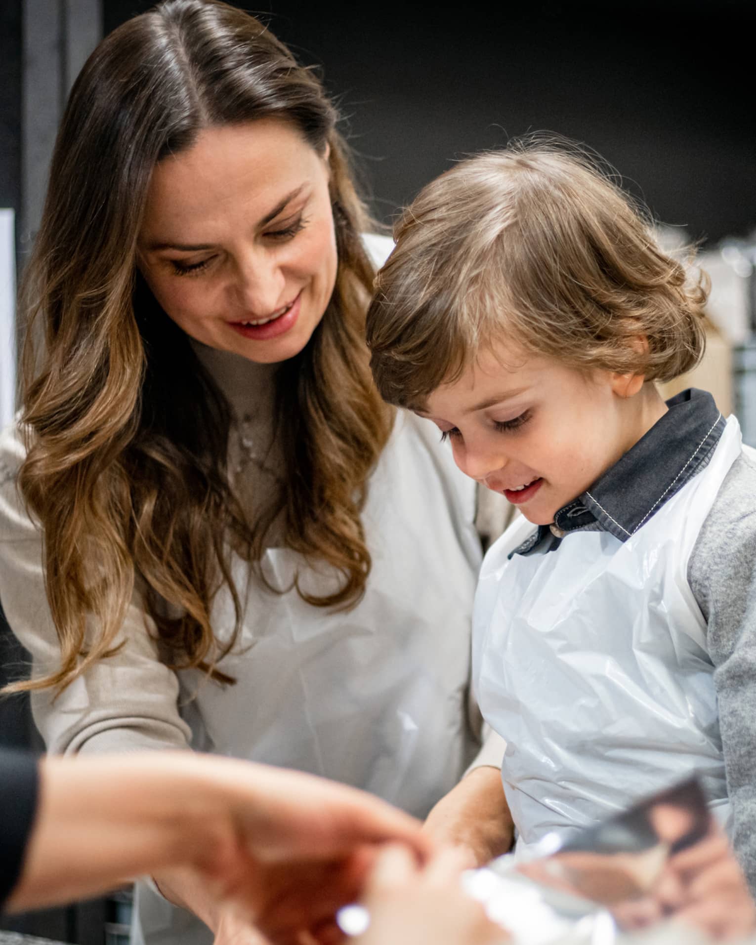 A family doing an activity in a kitchen.