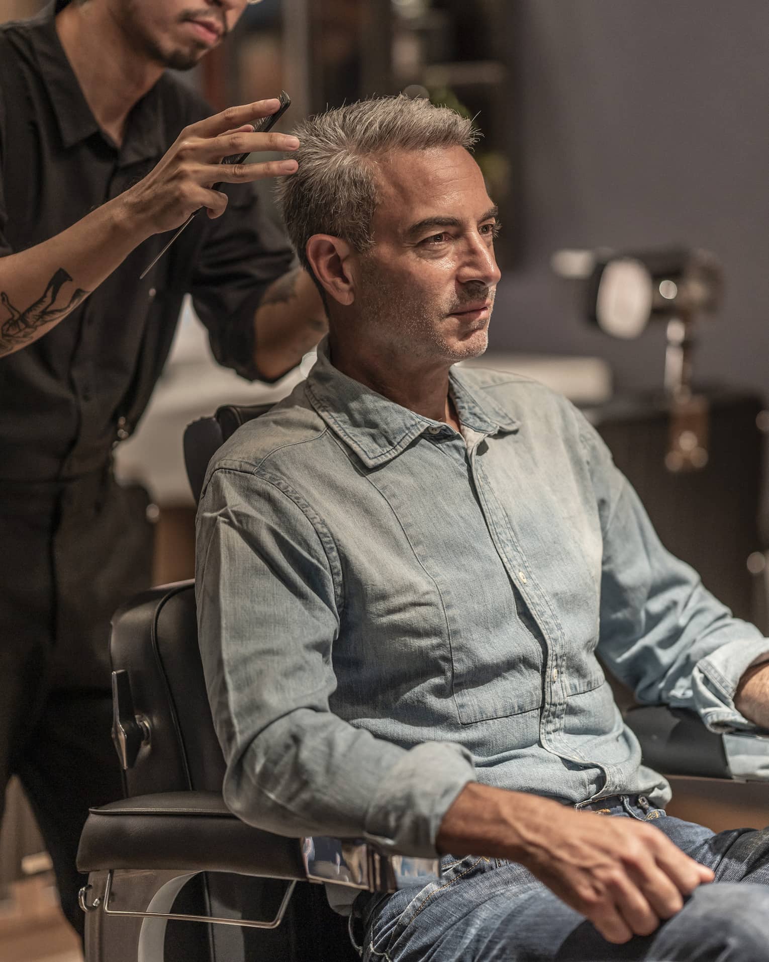 Man receives haircut in the Spa's barbershop