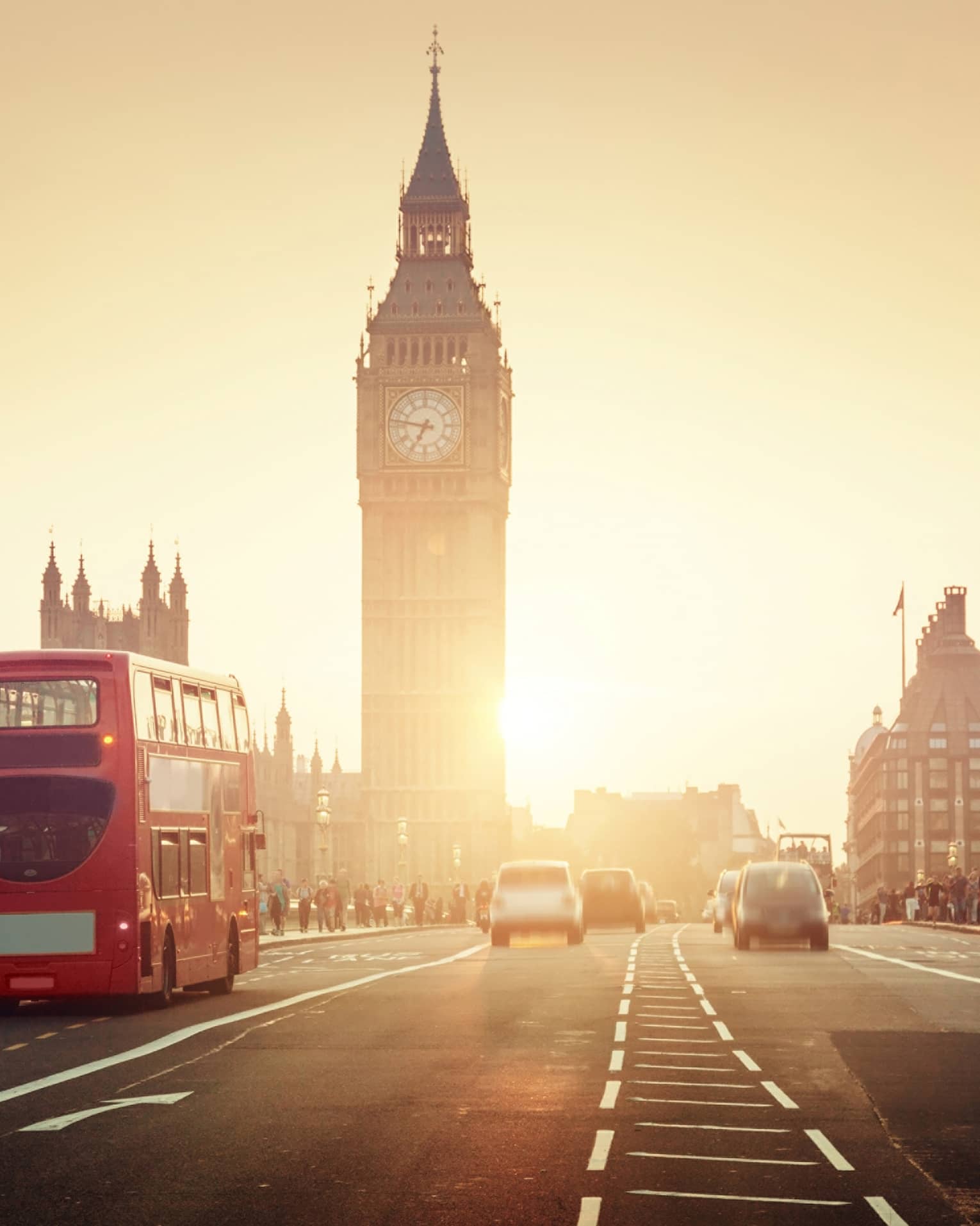 Street view of London at sunset, Big Ben tower and red double-decker bus in background