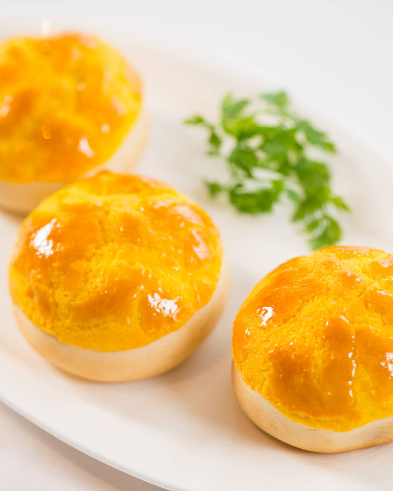Three Baked Barbecued Pork Buns with Pine Nuts on White Plate