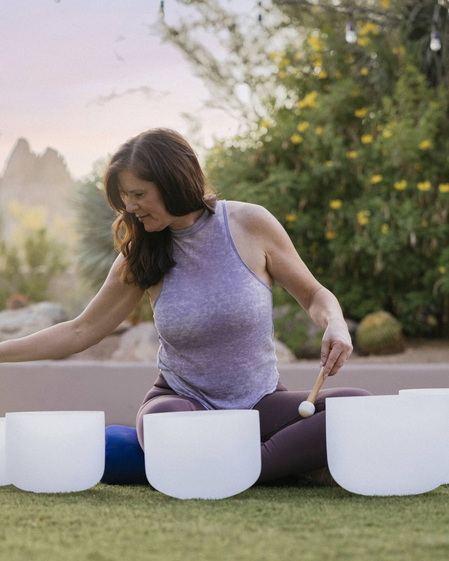 Person sitting outside doing a sound bowl meditation.