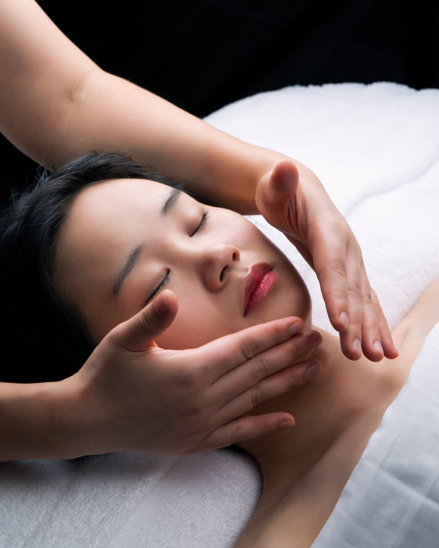 Guest laying on a spa table and getting a facial.