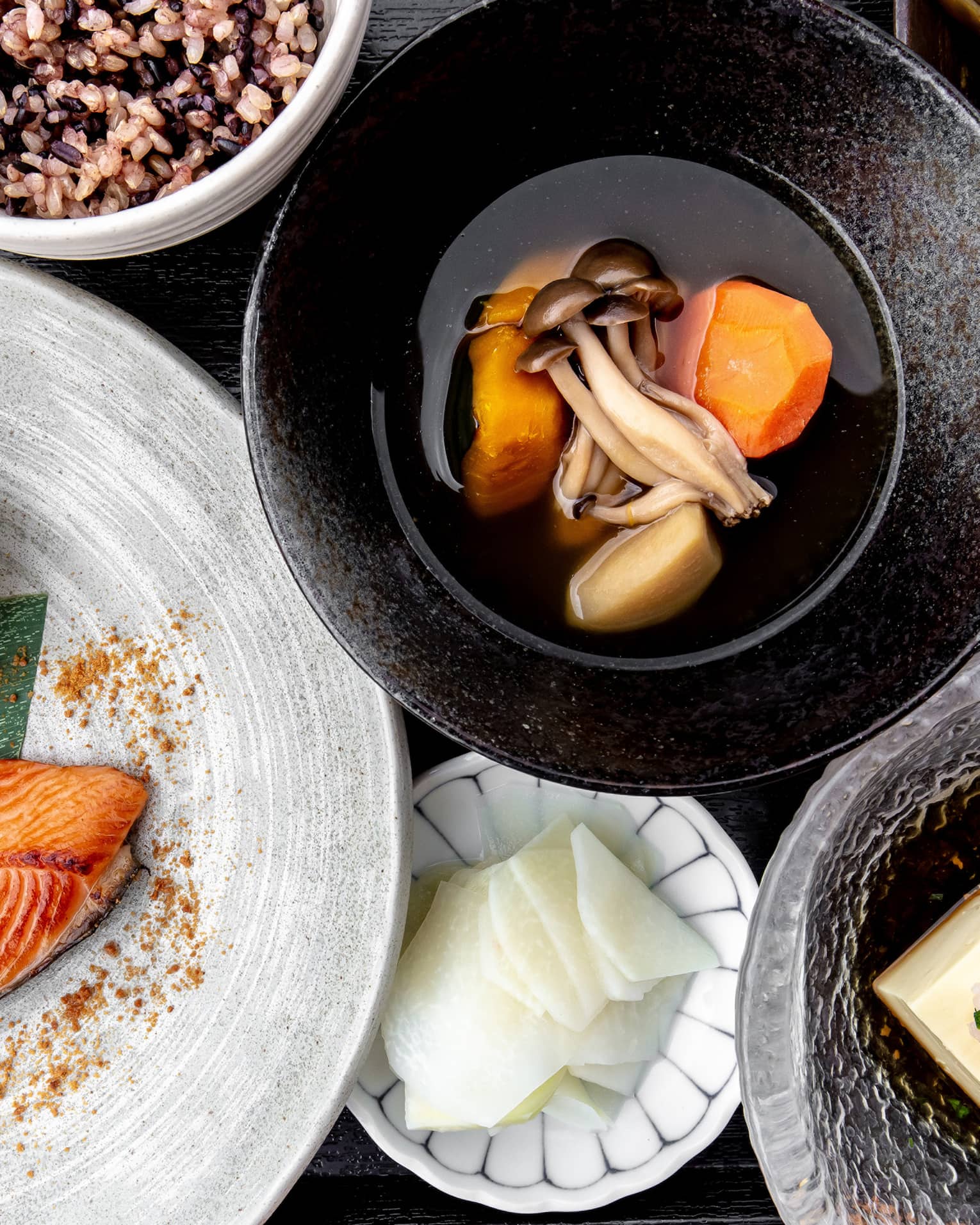 Aerial view of traditional Nourish spread, including salmon, sweet potato and mushroom soup