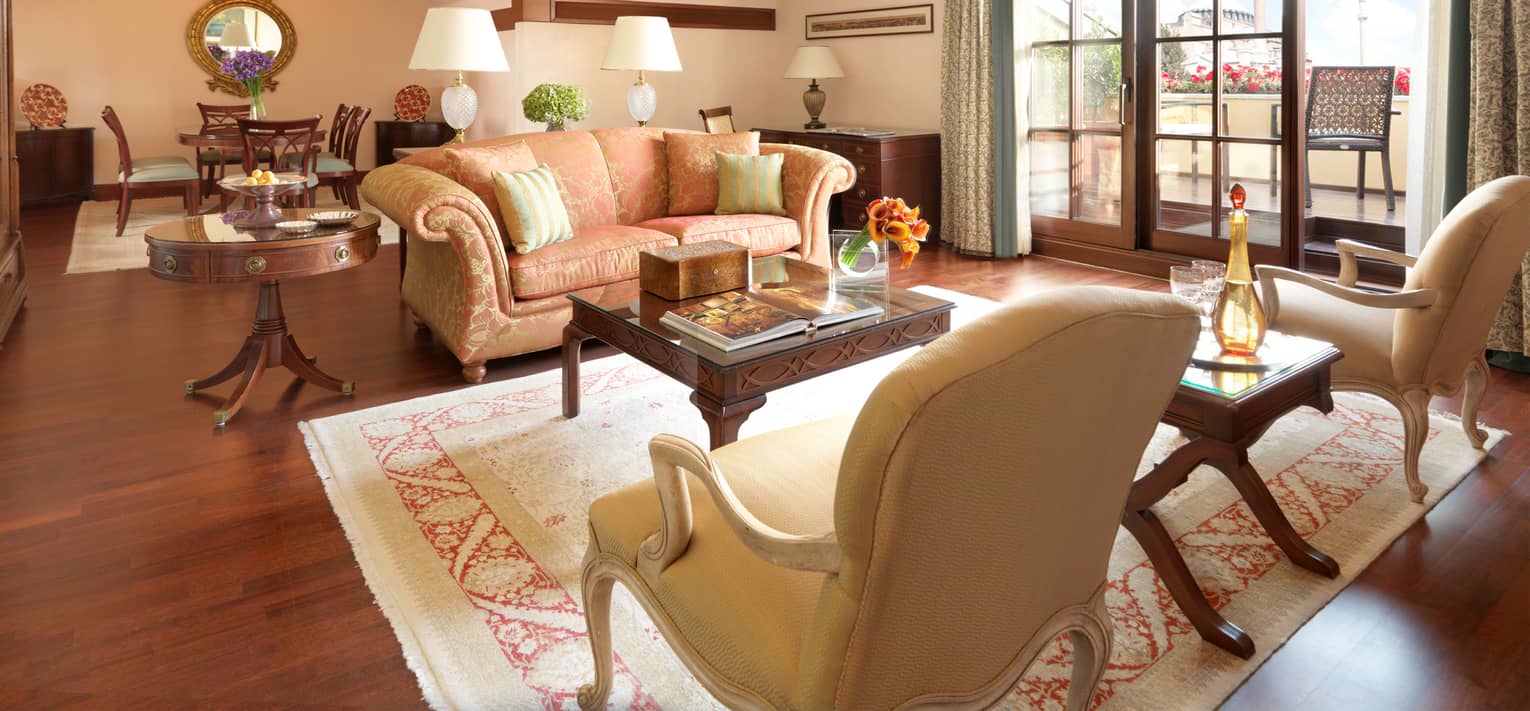 St. Sophia Suite with pink-and-gold sofa, armchairs under sloped ceiling