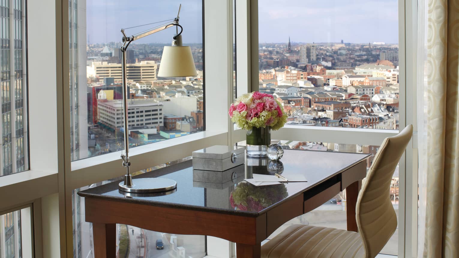 City-View Accessible Room writing desk with reading lamp, notepad, fresh flowers at window