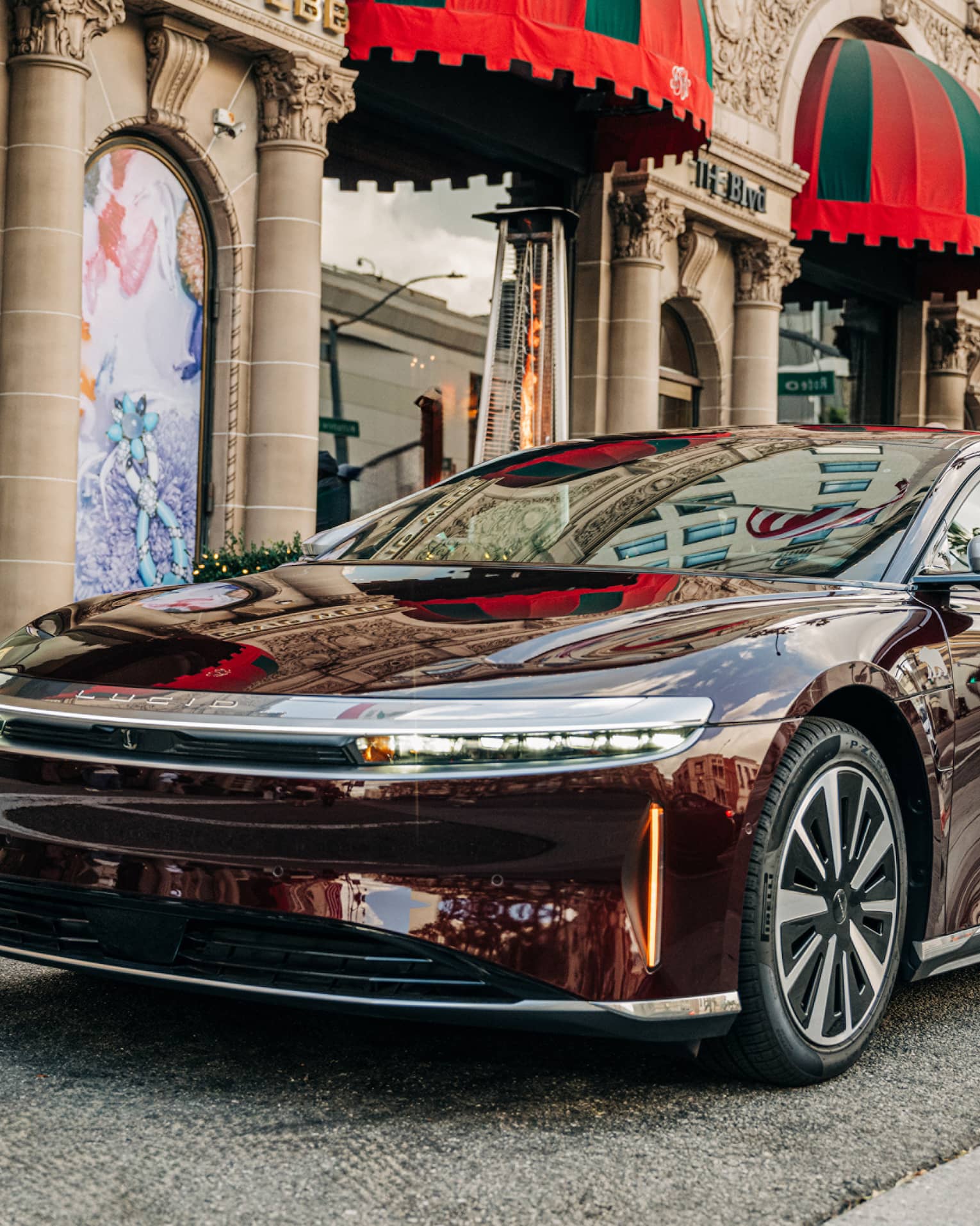 A hotel car parked on the street outside of the hotel