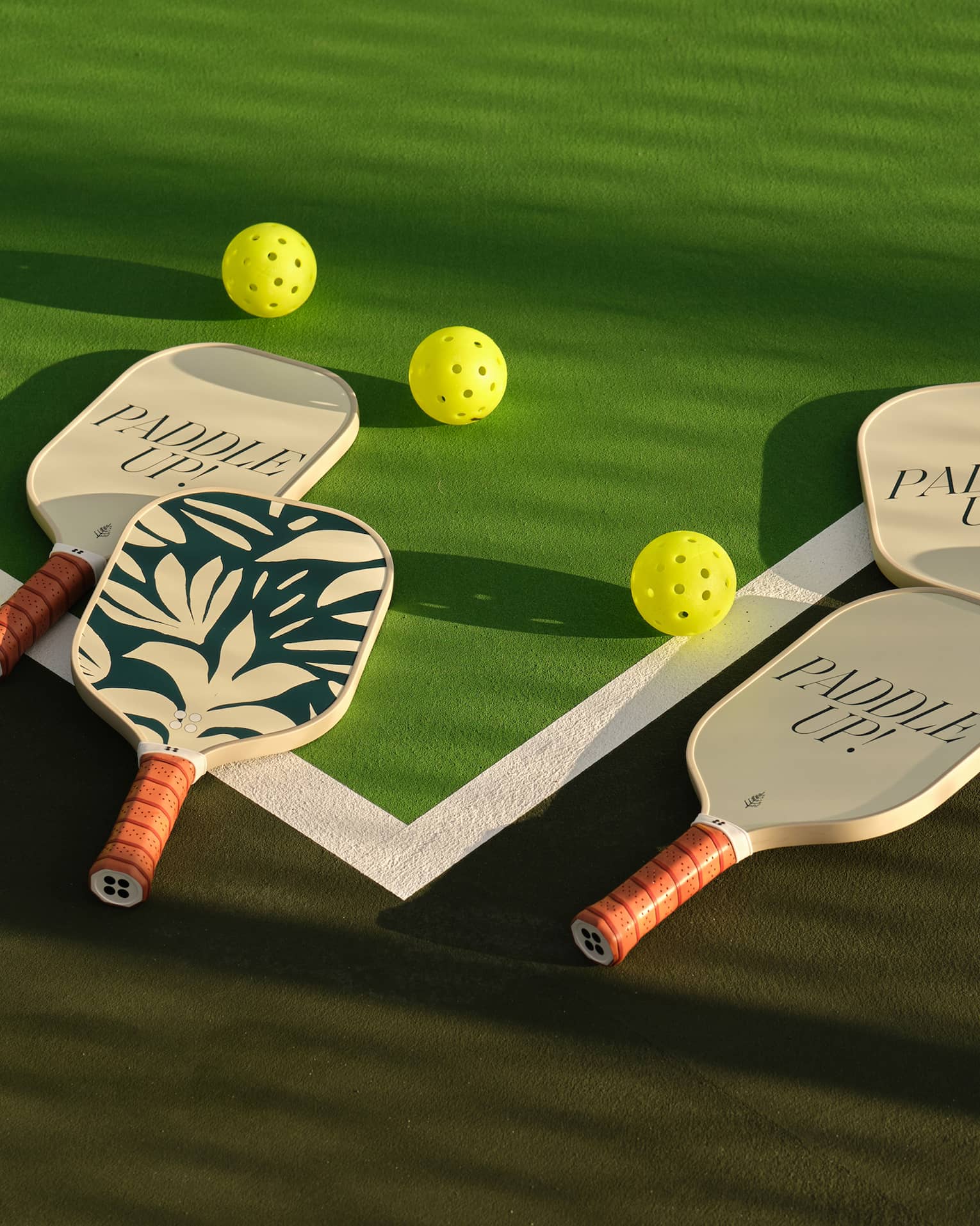Pickleball paddles on a pickleball court