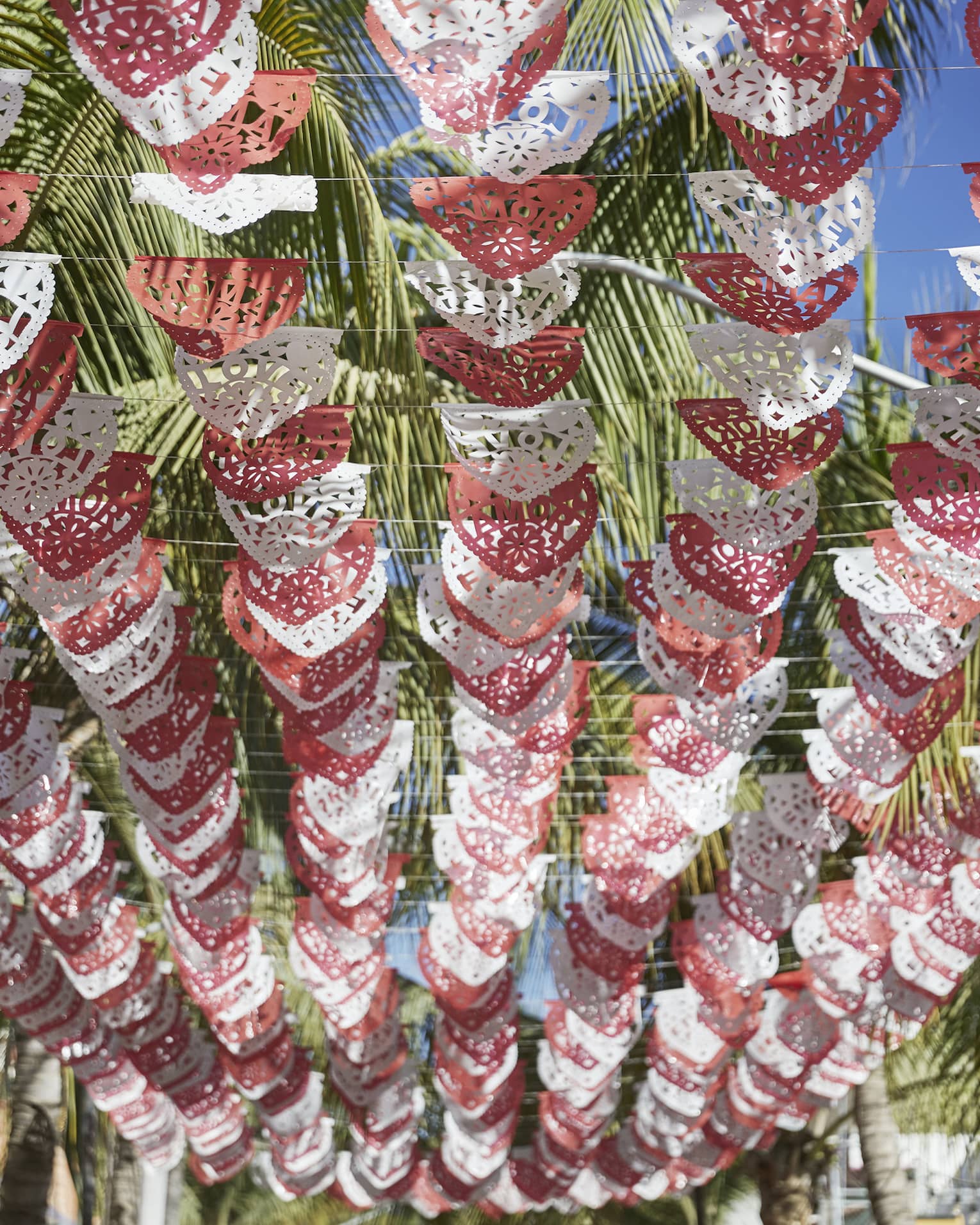 Rows of red and white paper banner flags with the word love 