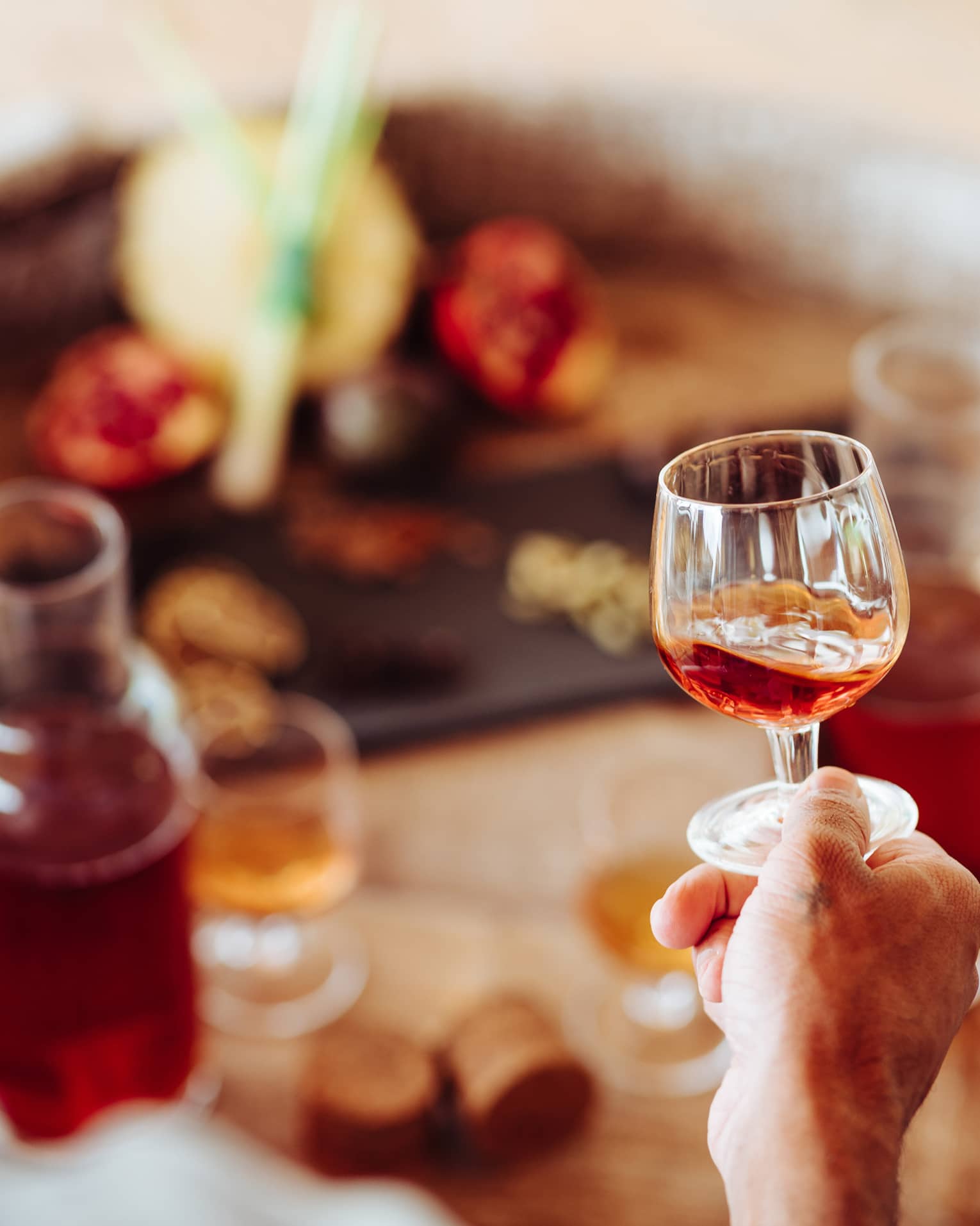 A person holding a clear glass of rum