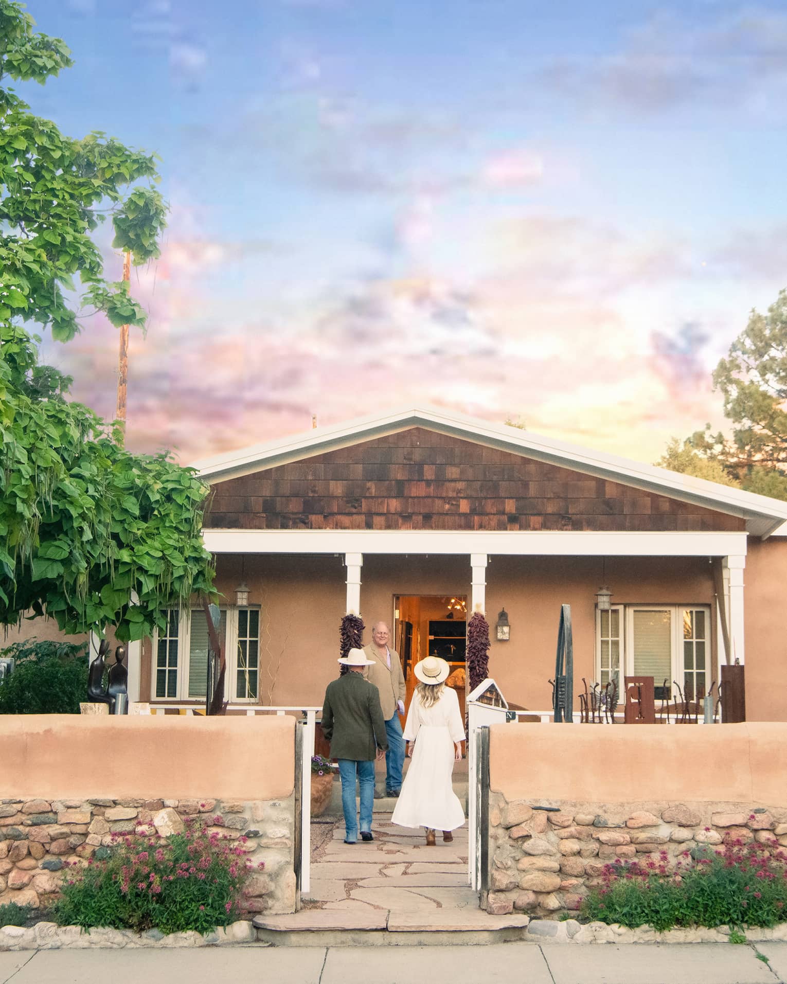 A man and woman walking up to a small building.