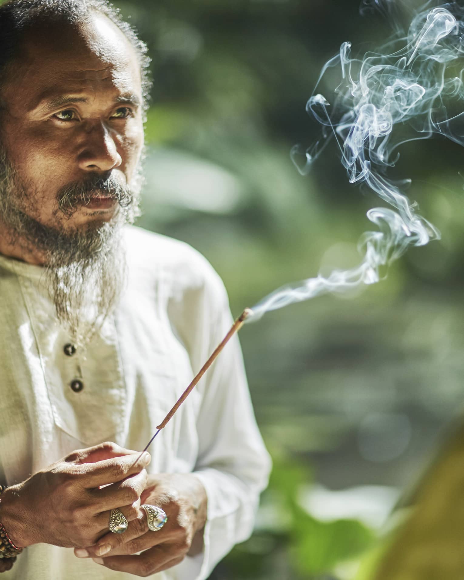 Balinese healer with burning incense