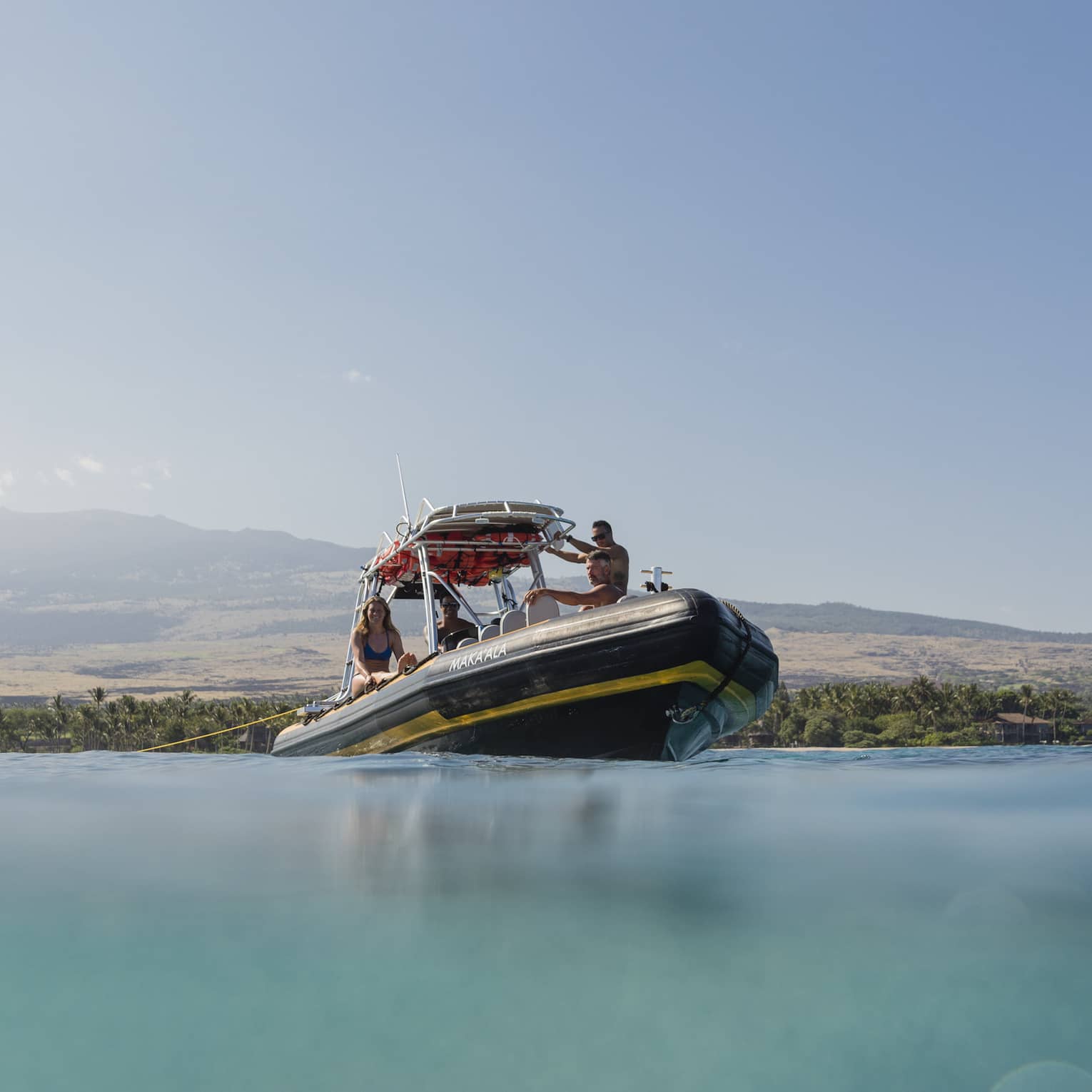A group of people enjoying the Coastal Aquatic Adventure on our Ribcraft boat off the shores of Hualalai
