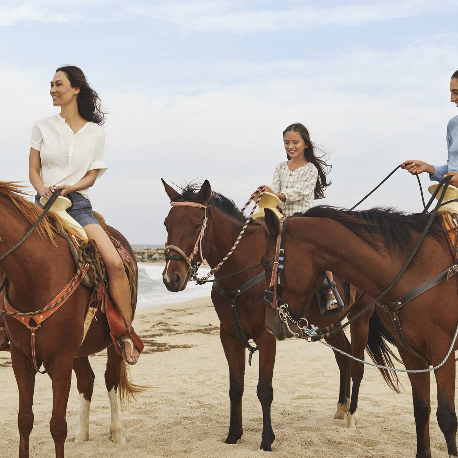 Three women riding on horses.