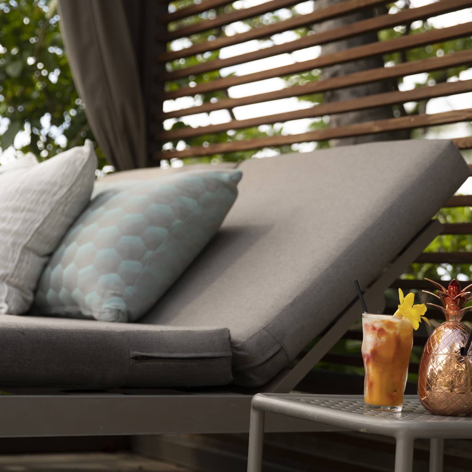 Cabana sunbed and cocktail in a tropical resort location