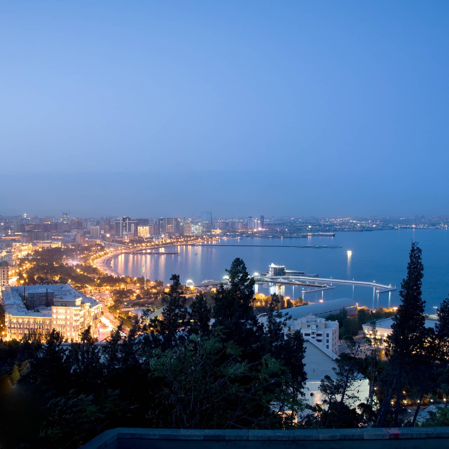 Aerial view of lights of Baku The Old City at night around Caspian Sea coastline