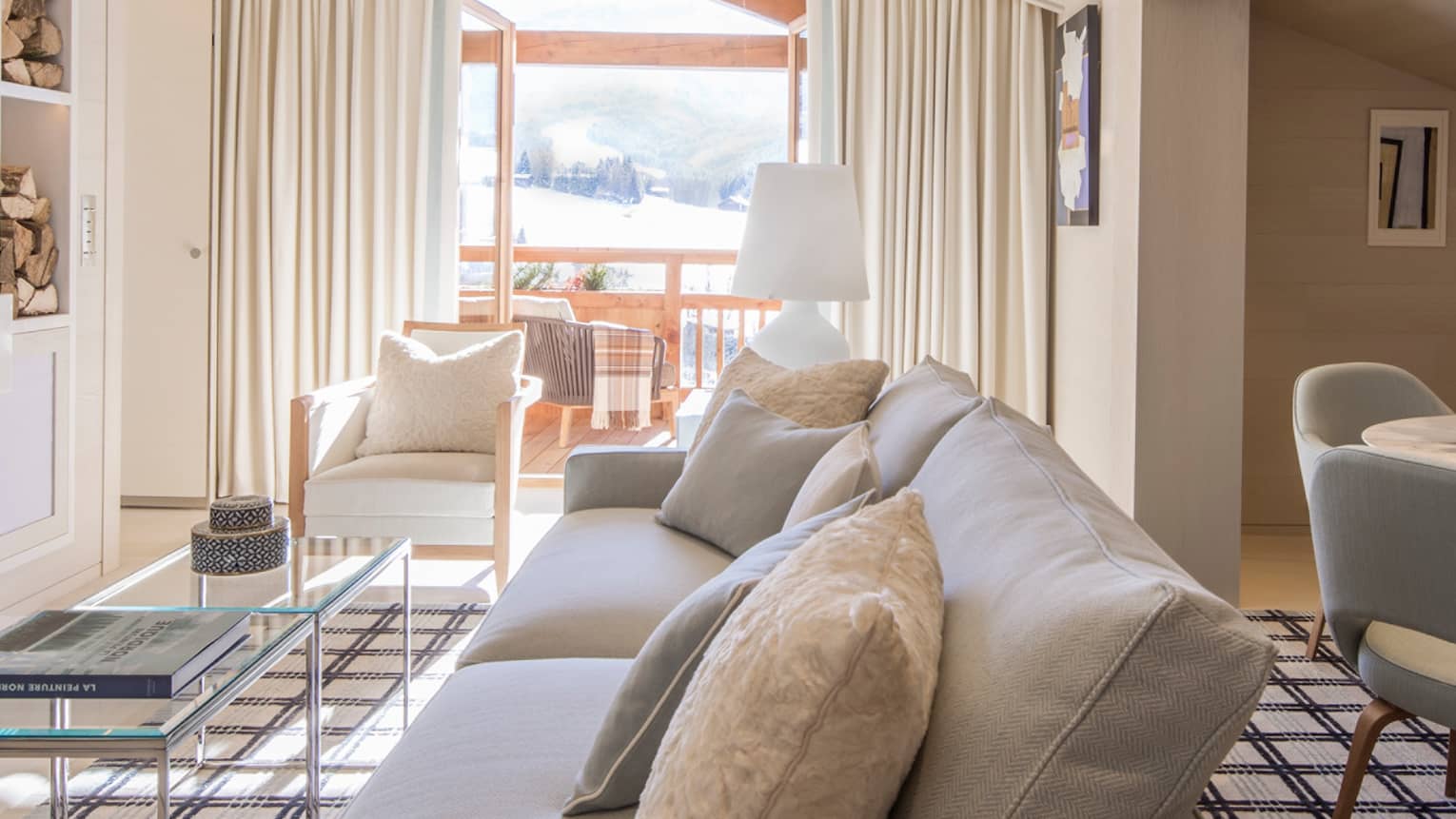 Suite Rochebrune white sofa, armchairs, glass table by modern fireplace, dining table