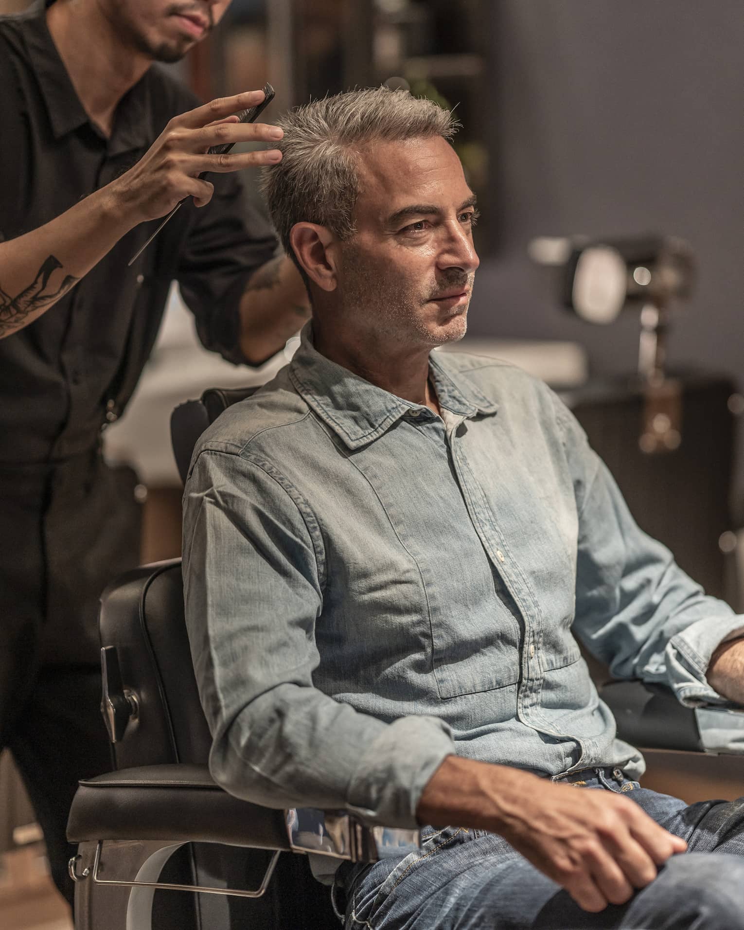 Man receives haircut in the Spa's barbershop