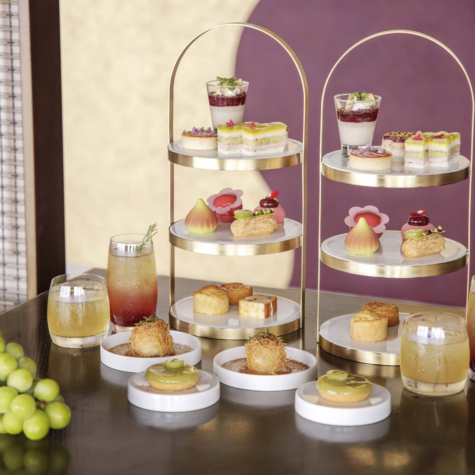 Afternoon tea spread on a table, featuring muscat grapes