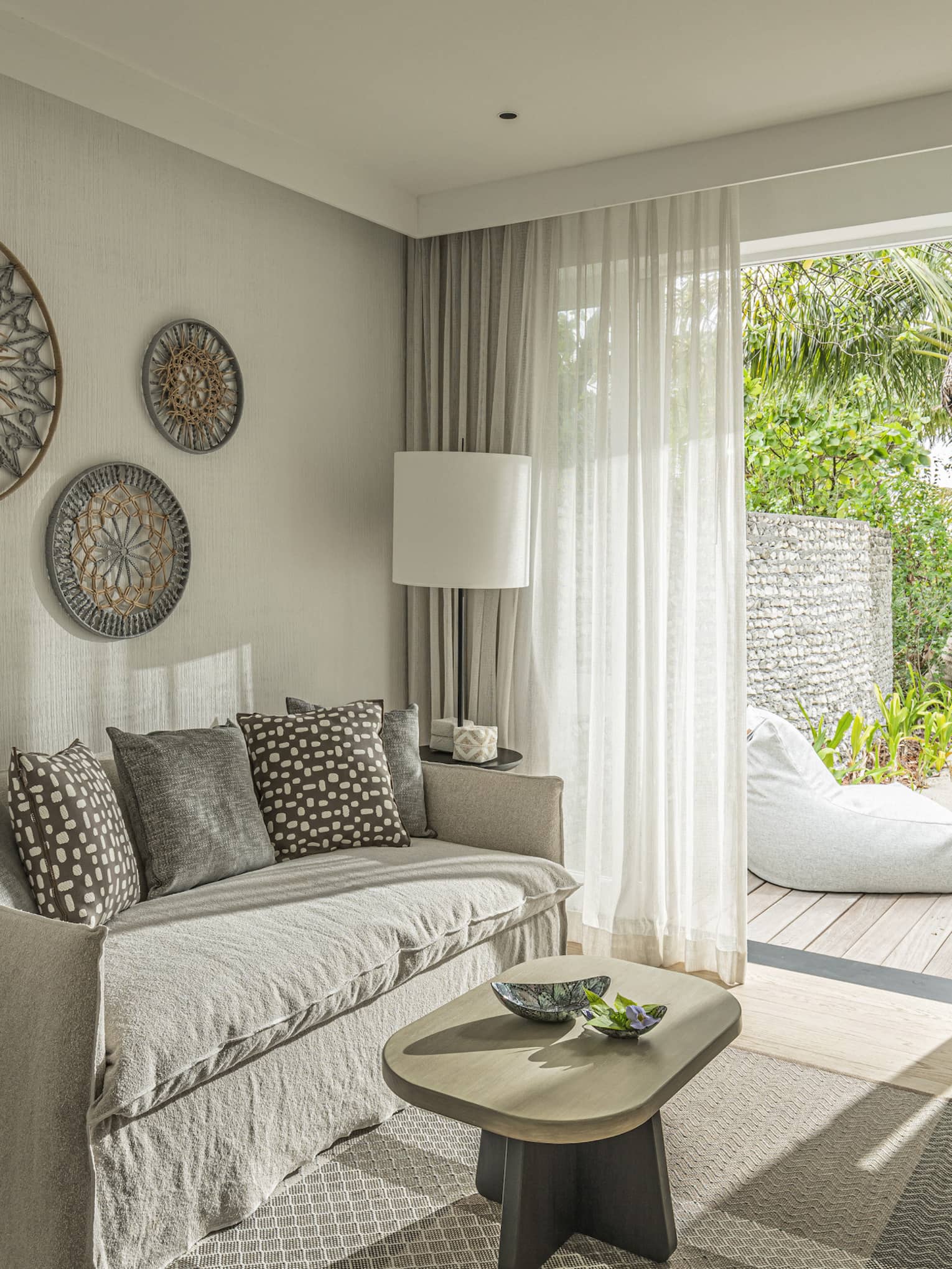 Bedroom with sofa, desk and walk-out deck with lounge chair