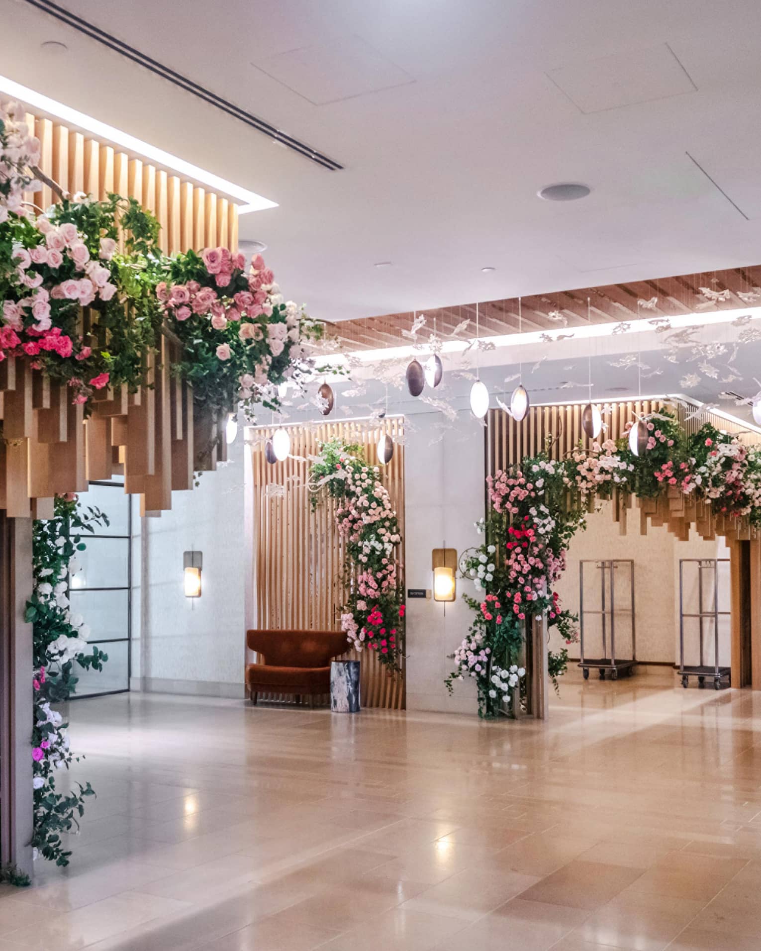 Each corner of the room is covered in bouquets of red, pink and white flowers.