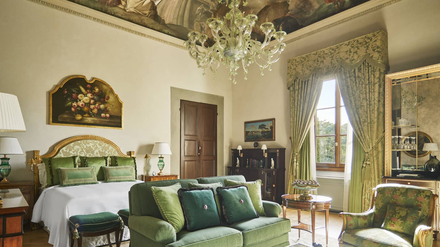Renaissance Suite king bedroom with frescoed ceiling and chandelier, at Four Seasons Hotel Florence