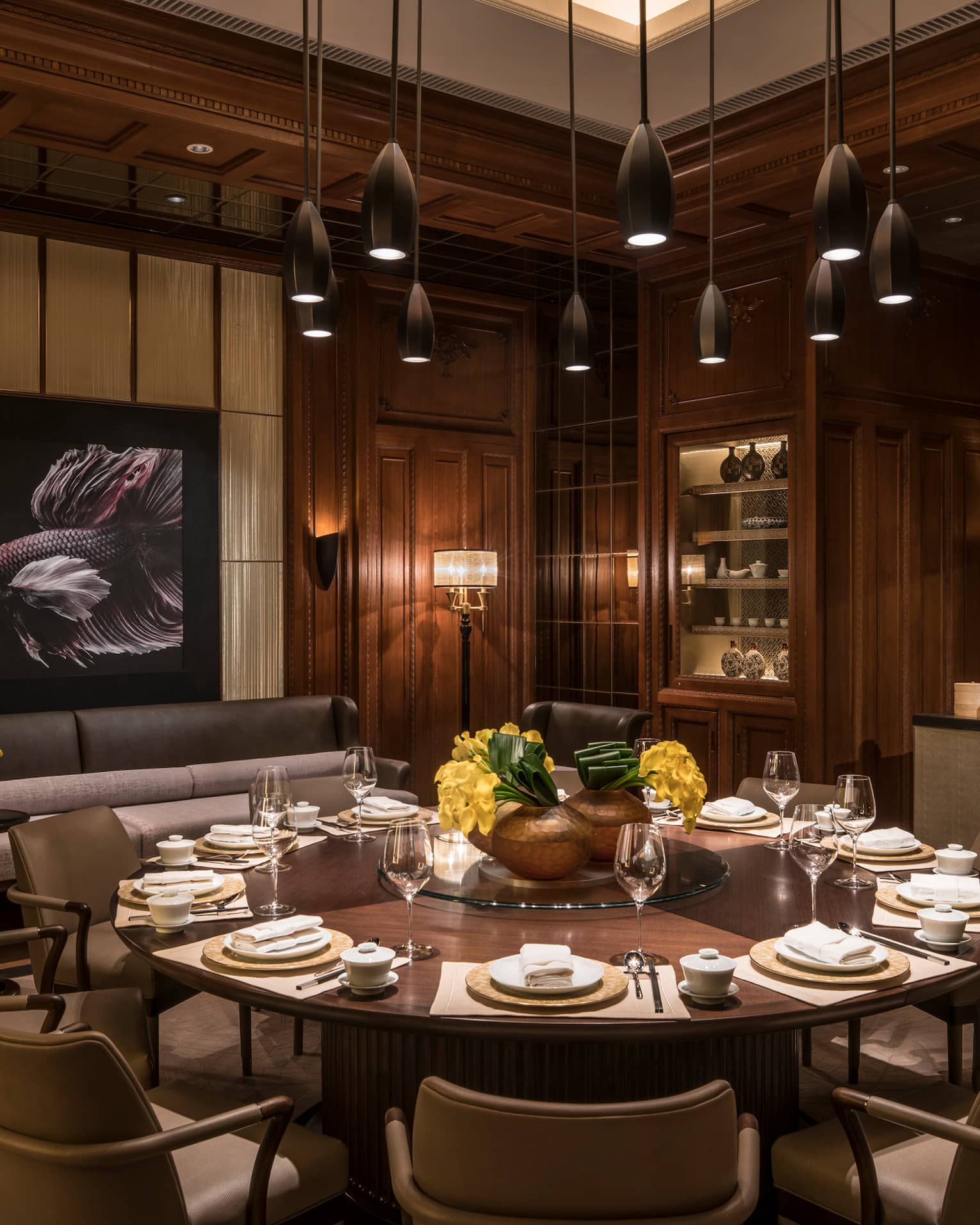 JIN restaurant, chef prepares food behind large round 12-seat table